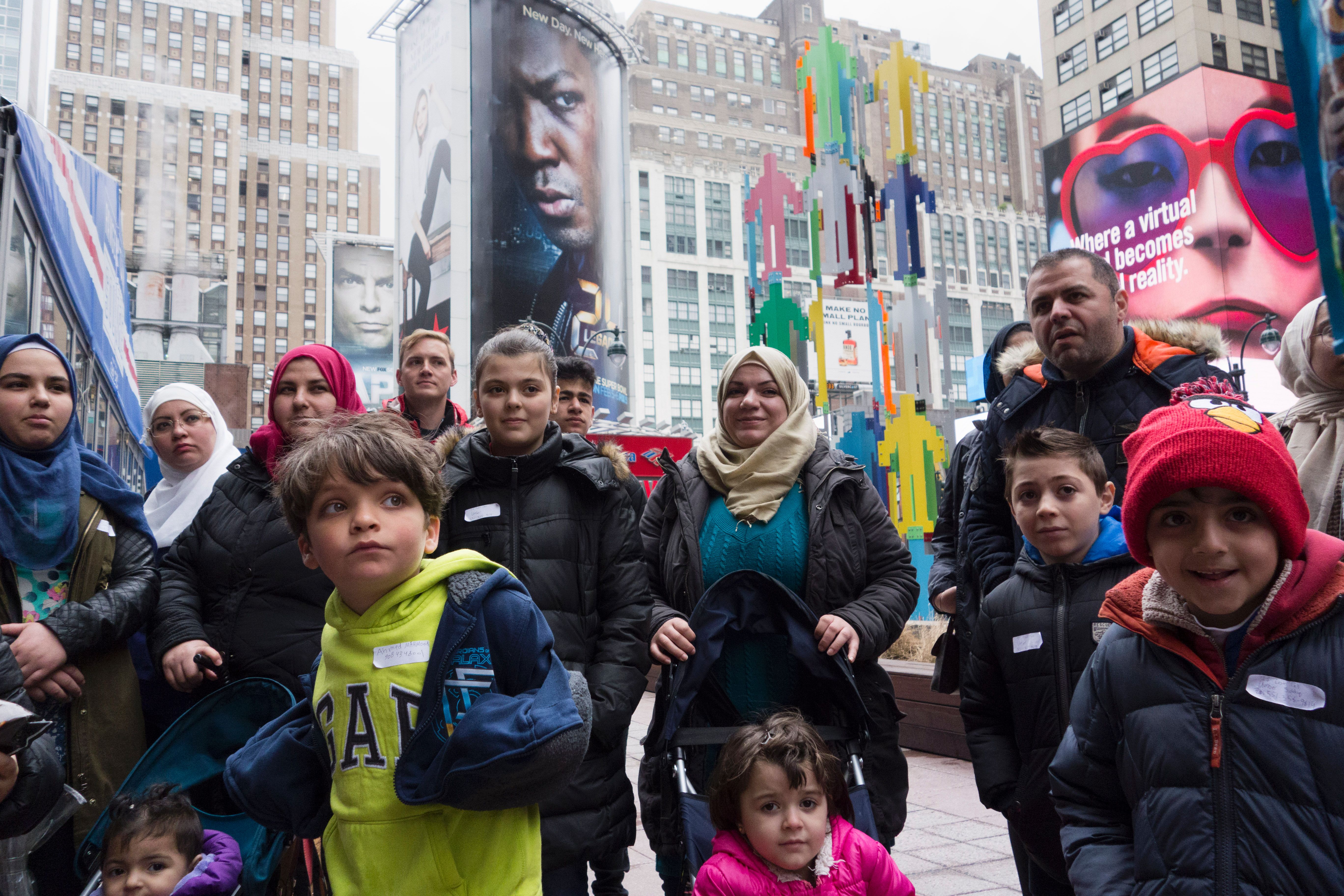 A group of Syrian and Iraqi refugee families gather outside Madison Square Garden for a tour of Manhattan on April 21, 2017, in New York City. (Credit: DON EMMERT/AFP/Getty Images)