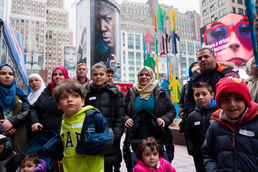 A group of Syrian and Iraqi refugee families gather outside Madison Square Garden for a tour of Manhattan on April 21, 2017, in New York City. (Credit: DON EMMERT/AFP/Getty Images)