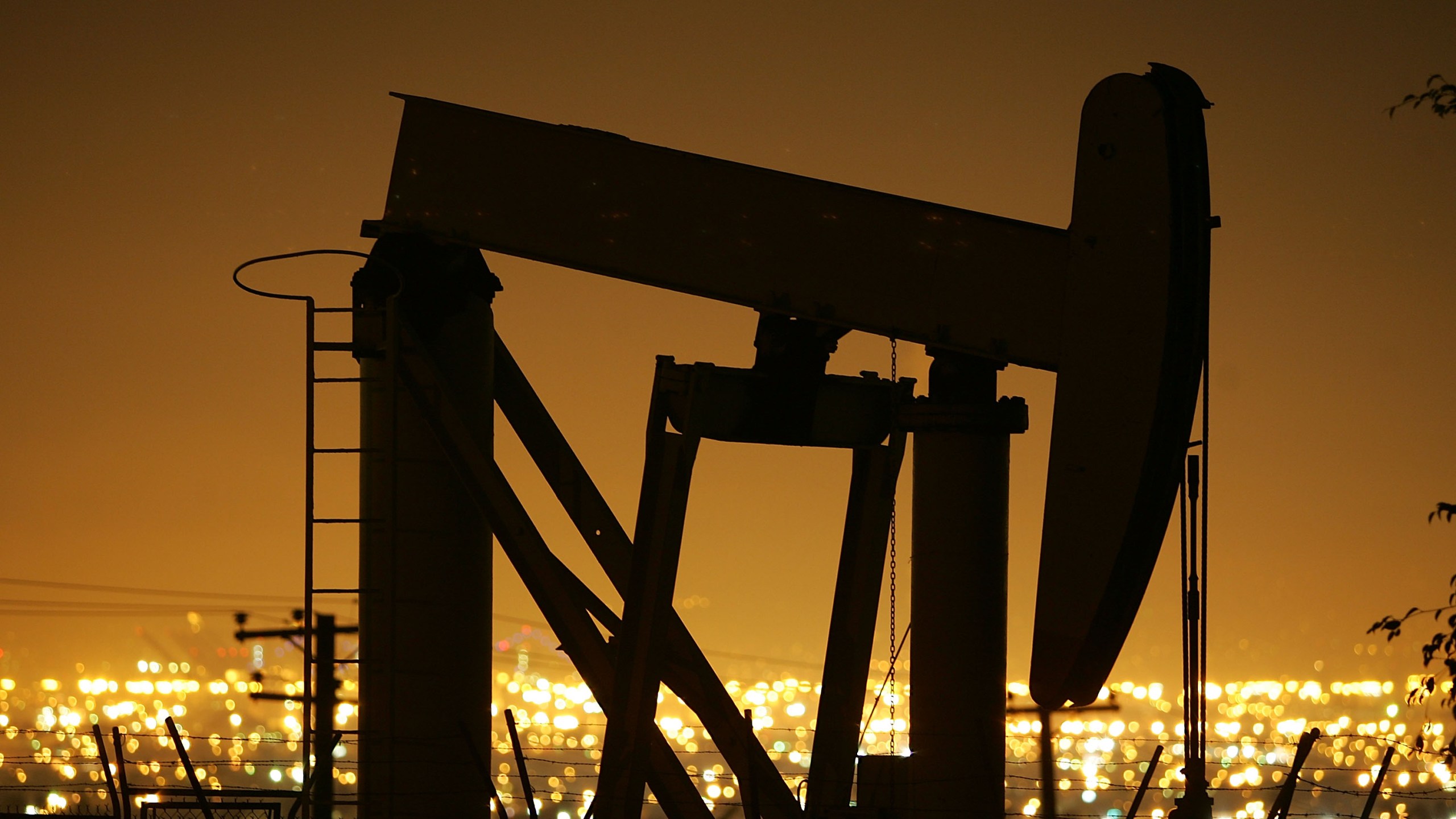 Pumps draw petroleum from oil wells through the night in Signal Hill on March 5, 2008. (Credit: by David McNew / Getty Images)