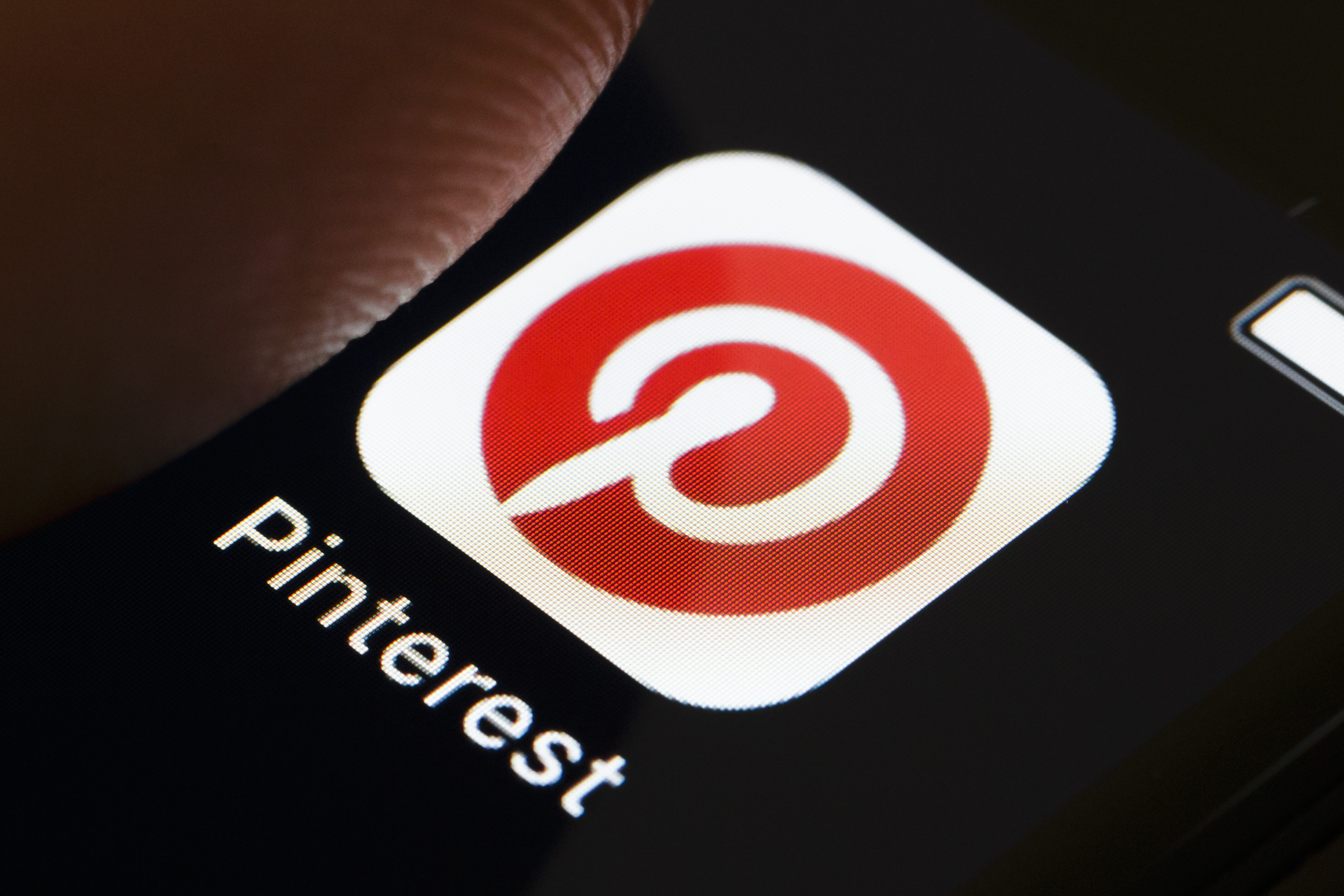 A photo illustration shows the PInterest app icon on a smartphone. (Credit: Thomas Trutschel/Photothek via Getty Images)