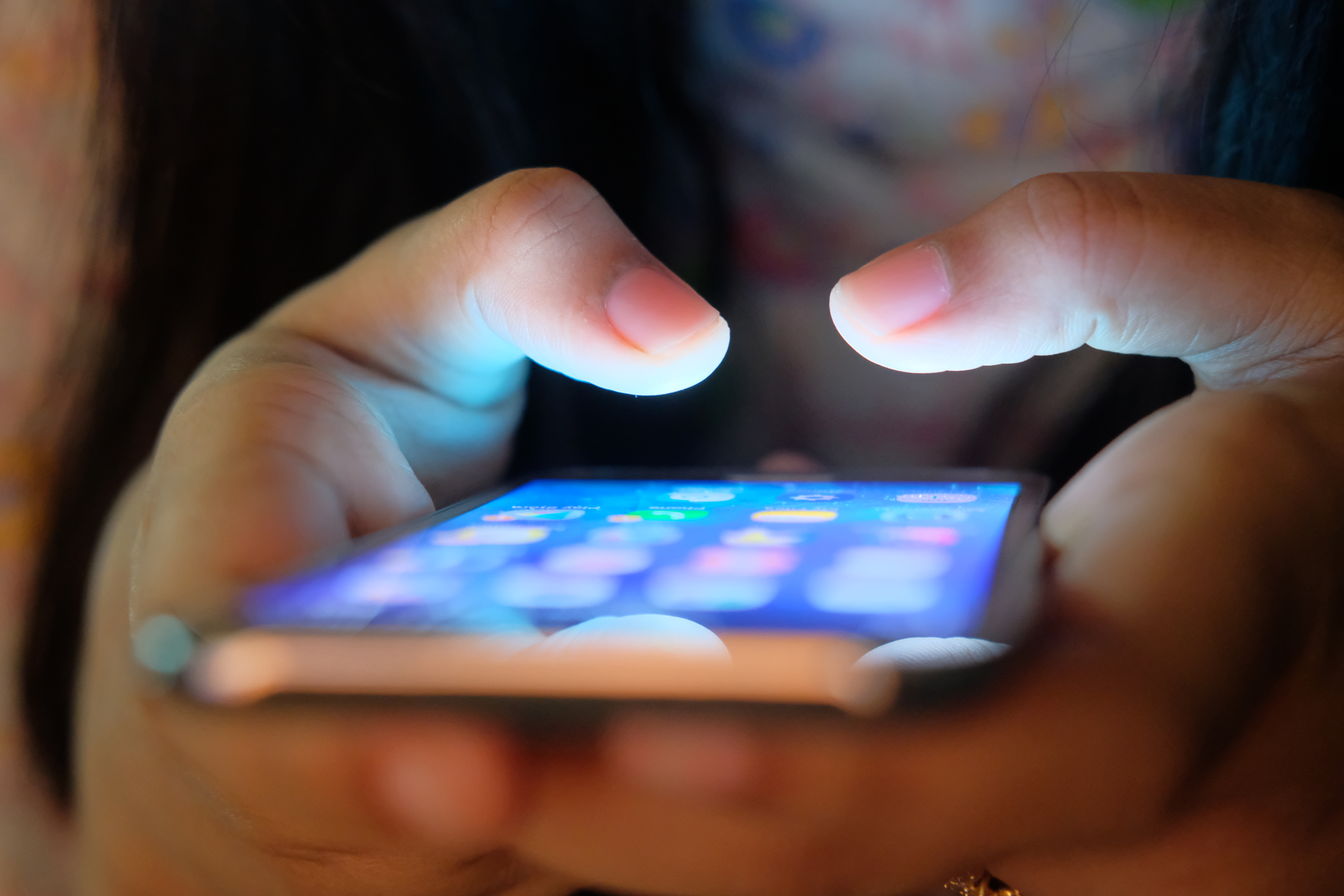 A woman uses a cellphone in this file photo. (Credit: Getty Images)