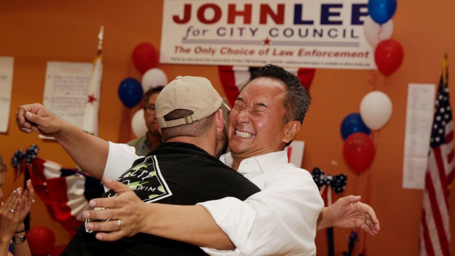 Newly elected councilman John Lee hugs a longtime friend during his election night party. (Credit: Liz Moughon / Los Angeles Times)