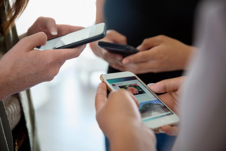 People are seen using smart phones in this undated photo. (Credit: Hero Images/ Getty Images via CNN)