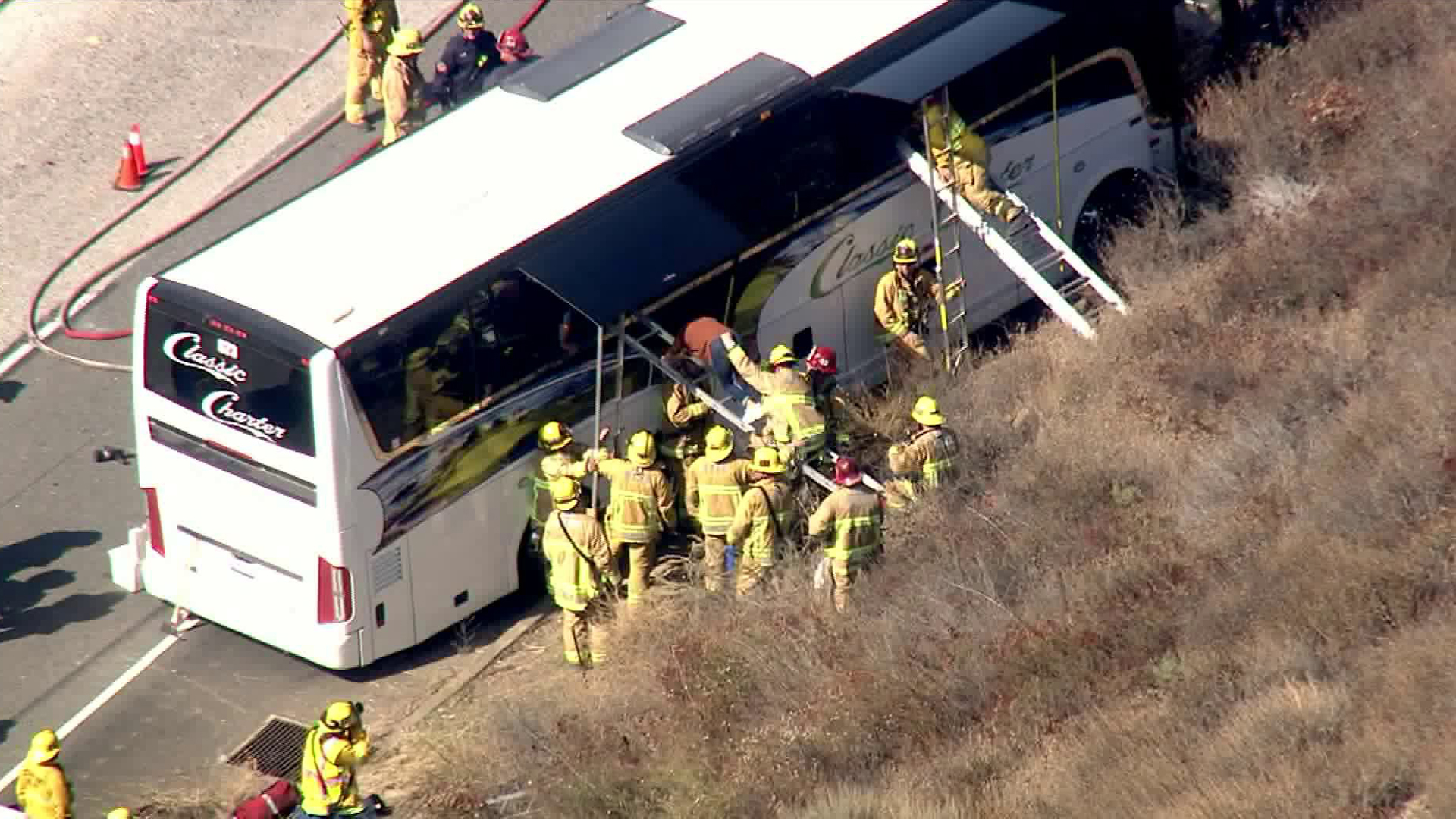 Firefighters work to get passengers off a charter bus after a crash on the 118 Freeway in Simi Valley on Sept. 3, 2019. (Credit: KTLA)