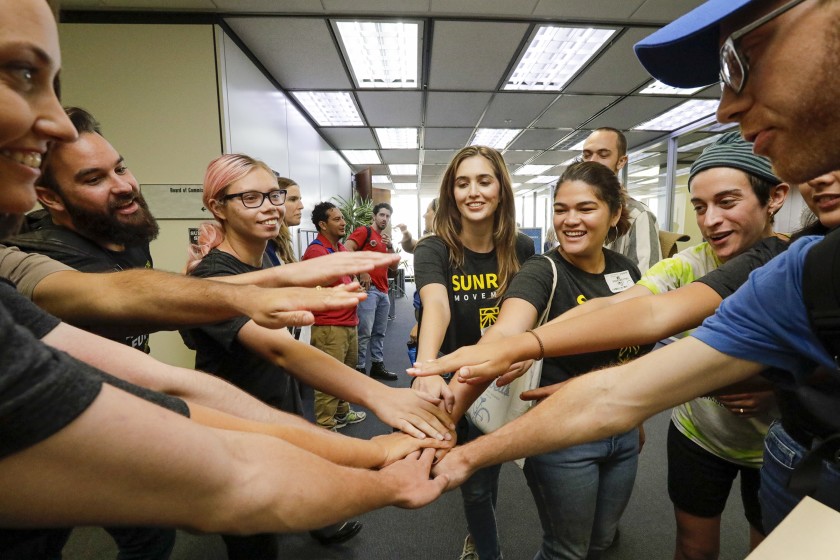 Environmental activists celebrate on Sept. 10, 2019, after the Los Angeles Department of Water and Power approved a record-cheap, 25-year deal for solar power and battery storage. (Credit: Irfan Khan / Los Angeles Times)