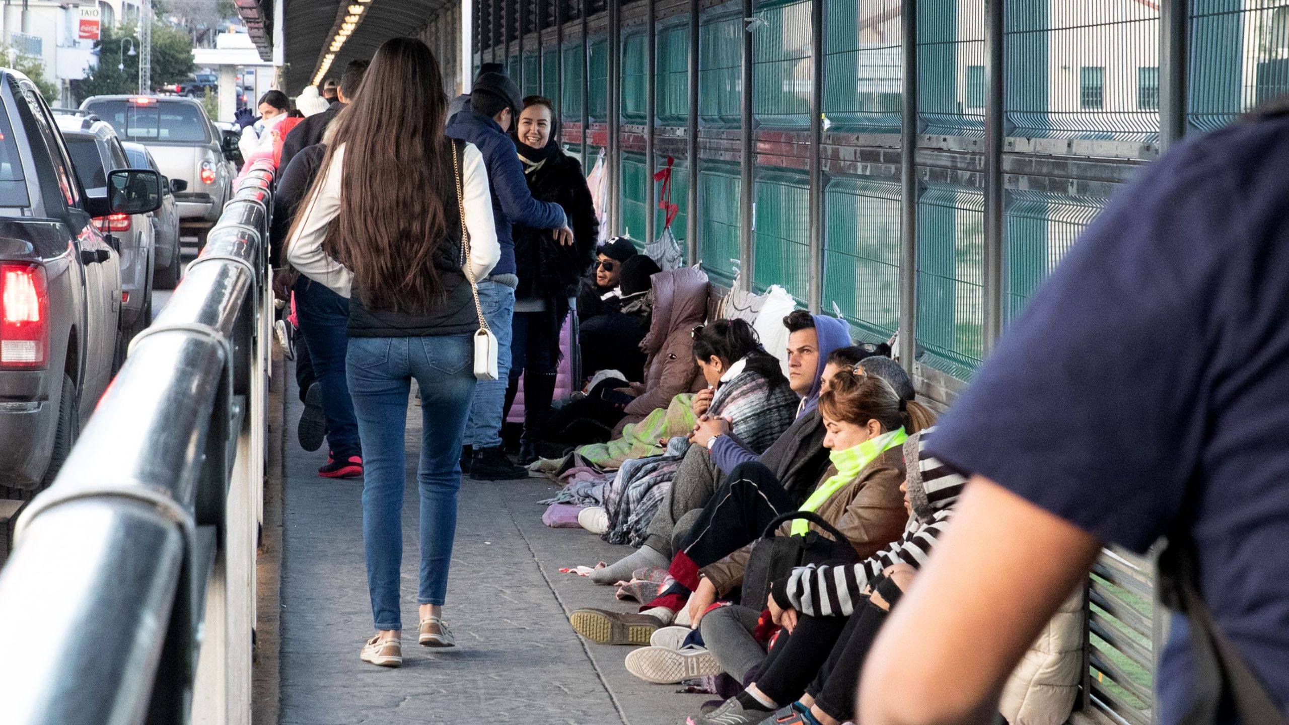 Asylum seekers await processing on the international bridge on the U.S.-Mexico border in Laredo, Texas, on Jan. 13, 2019. (Credit: Suzanne Cordeiro / AFP / Getty Images)