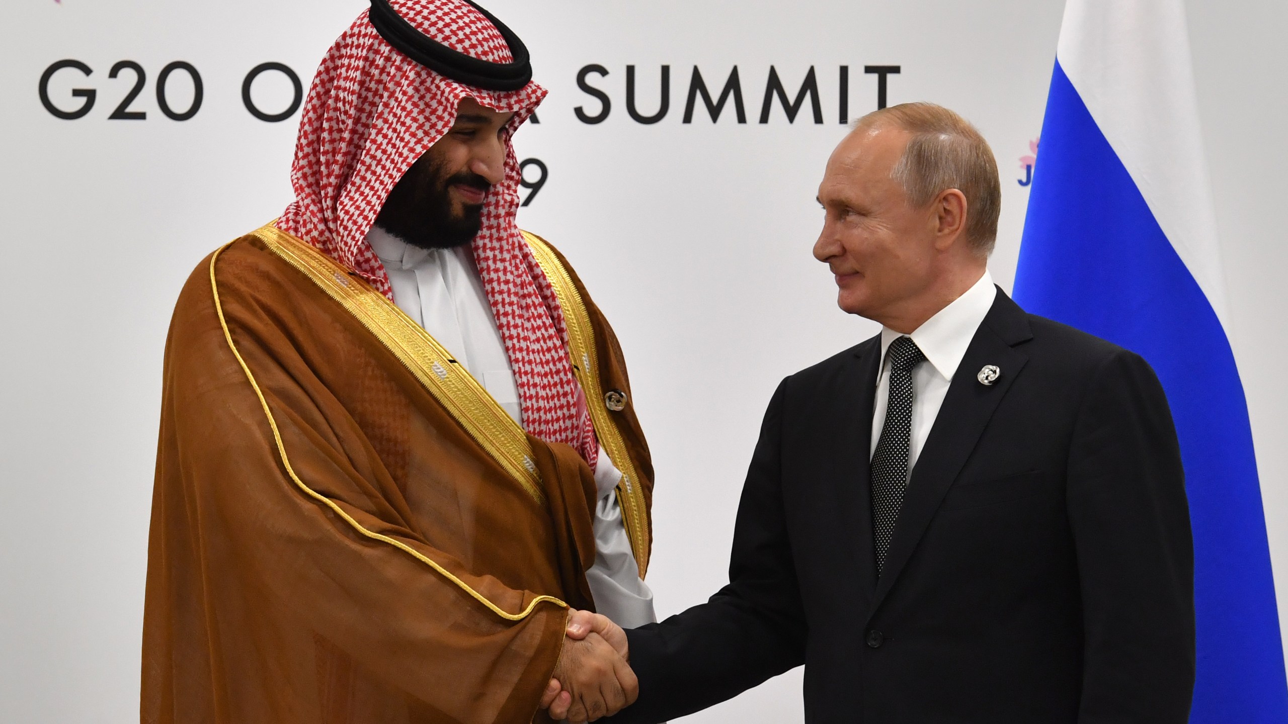 Russia's President Vladimir Putin, right, shakes hands with Saudi Arabia's Crown Prince Mohammed bin Salman during a meeting on the sidelines of the G20 Summit in Osaka, Japan, on June 29, 2019. (Credit: Yuri Kadobnov / AFP / Getty Images)