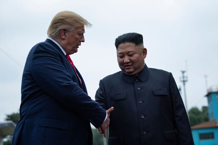 U.S. President Donald Trump and North Korea's leader Kim Jong-un shake hands before a meeting in the Demilitarized Zone (DMZ) on June 30, 2019. (Credit: BRENDAN SMIALOWSKI/AFP/Getty Images)