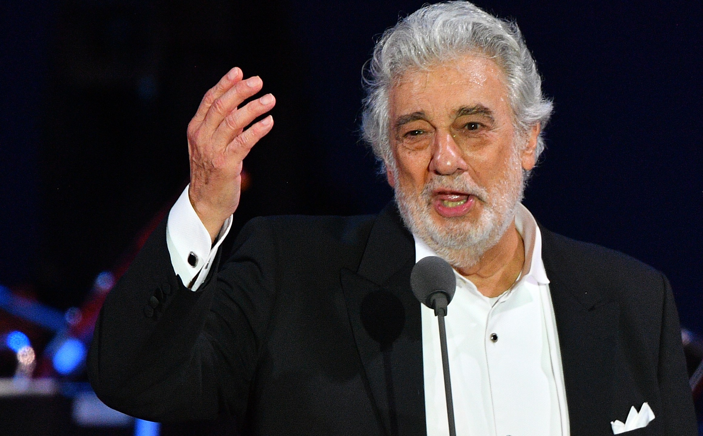 Spanish tenor Placido Domingo gestures as he performs during his concert in Szeged, southern Hungary, on Aug. 28, 2019. (Credit: Attila Kisbenedek / AFP / Getty Images)