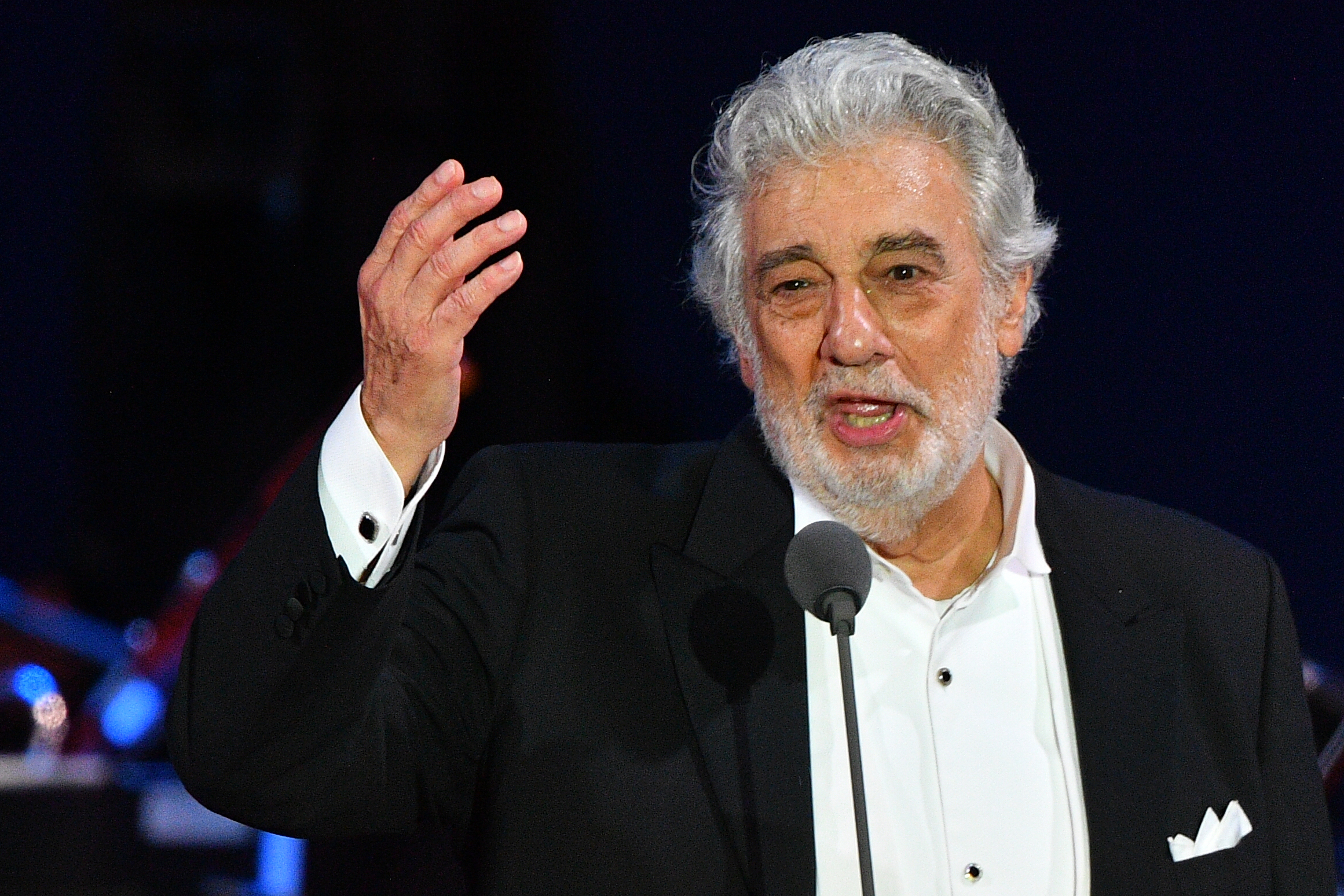 Spanish tenor Placido Domingo gestures as he performs during his concert in Szeged, southern Hungary, on Aug. 28, 2019. (Credit: Attila Kisbenedek / AFP / Getty Images)