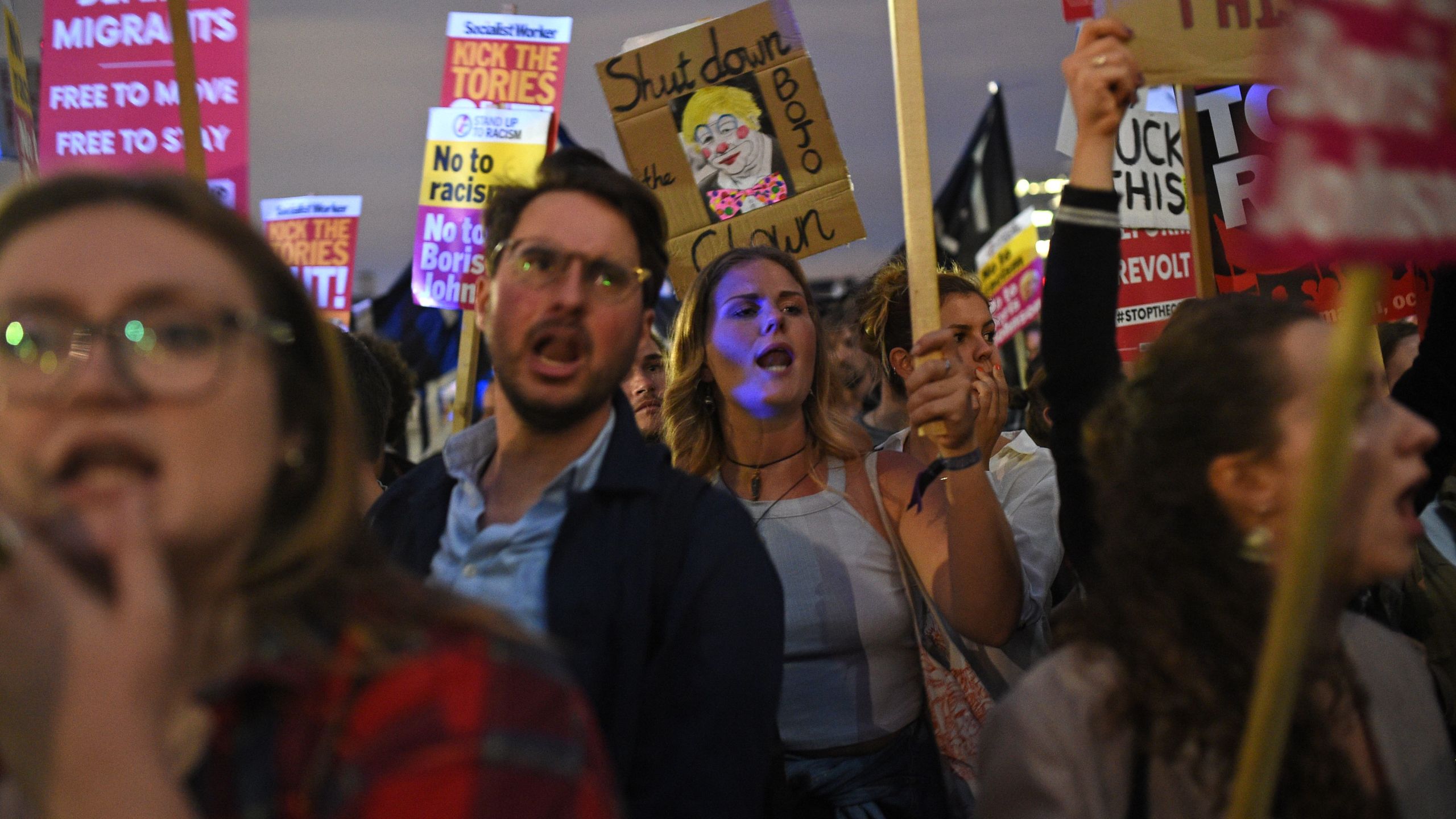 Demonstrators carry placards during a protest outside the Houses of Parliament in central London on Sept. 3, 2019, hosted by The People's Assembly Against Austerity. (Credit: Oli Scarff / AFP / Getty Images)