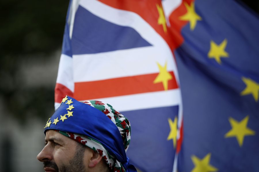 An activist wears a bandana of EU colors at a cross-party rally organized by the People's Vote organization campaigning for a second EU referendum, outside the Houses of Parliament in central London, on Sept. 4, 2019. (Credit: Tolga Akmen / AFP / Getty Images)