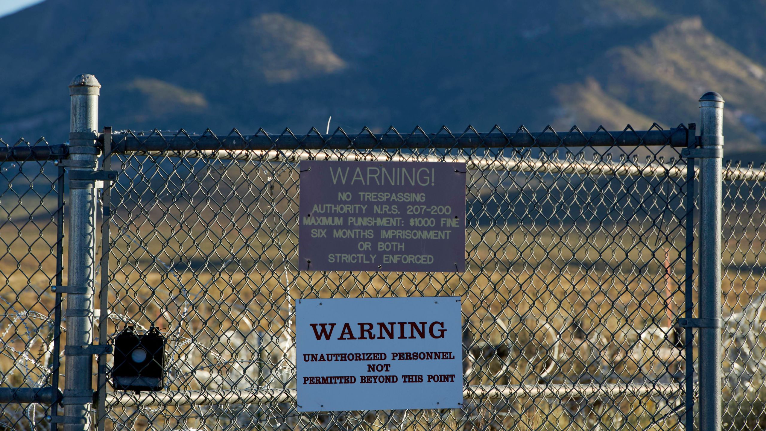 Signage is posted outside a gate of the Nevada Test and Training Range, commonly referred to as Area 51, near Rachel, Nevada, on September 13, 2019. (Credit: BRIDGET BENNETT/AFP/Getty Images)