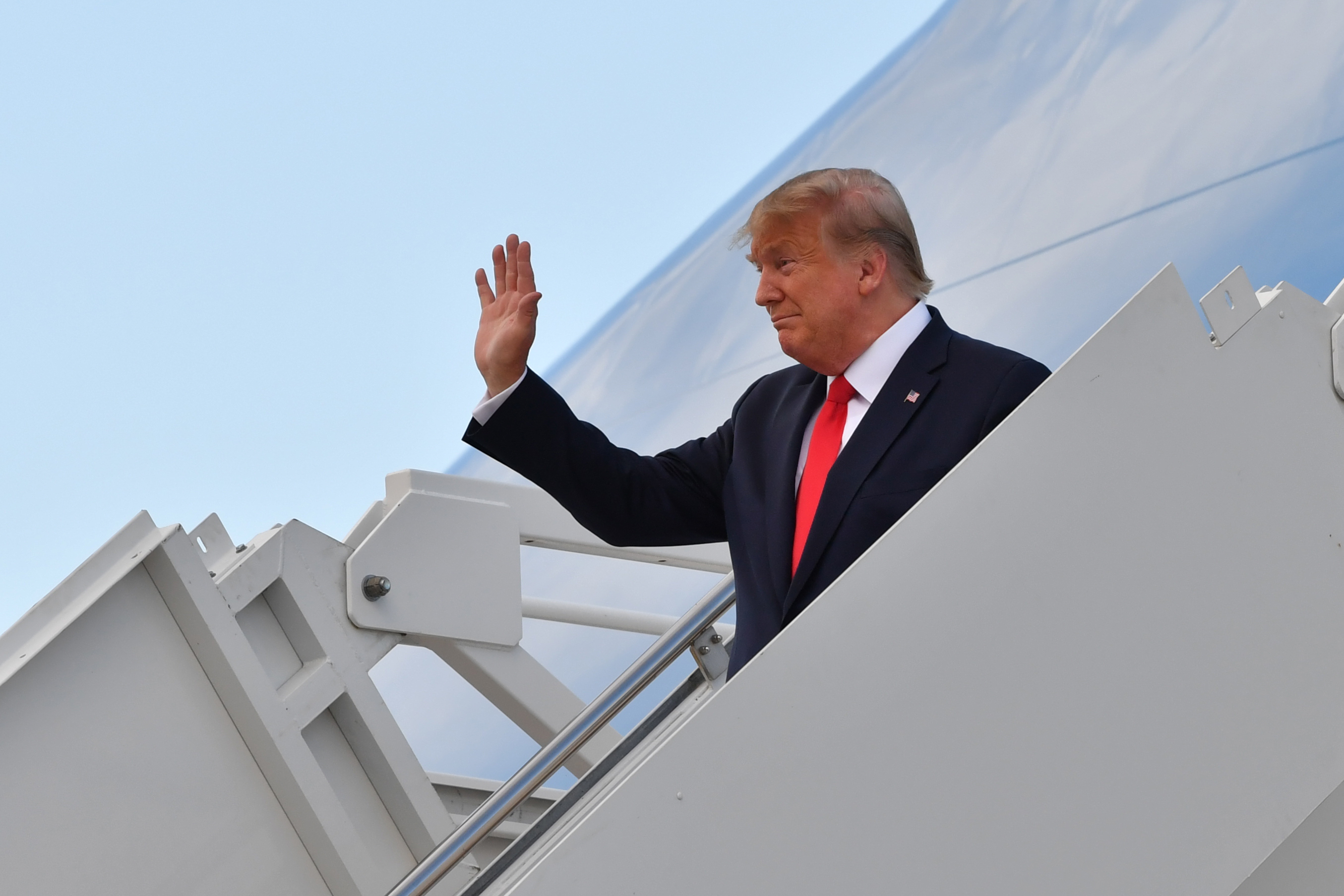 President Donald Trump waves as he steps off Air Force One at Albuquerque International Sunport in New Mexico on Sept. 16, 2019. (Credit: Nicholas Kamm / AFP / Getty Images)