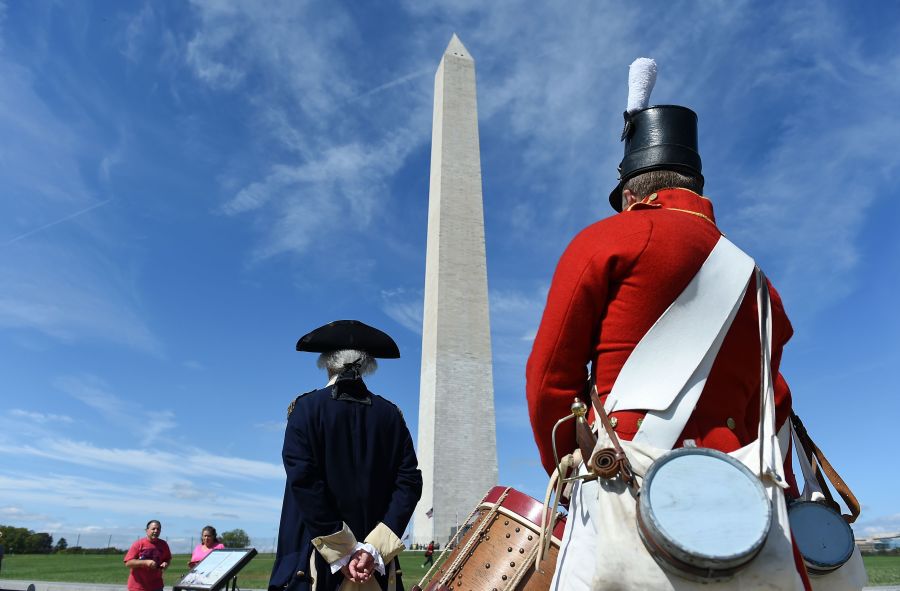 People dressed in historical costumes participate in the reopening of the Washington Monument on Sep. 19, 2019, in Washington, DC. (Credit: Olivier Douliery/AFP/Getty Images)