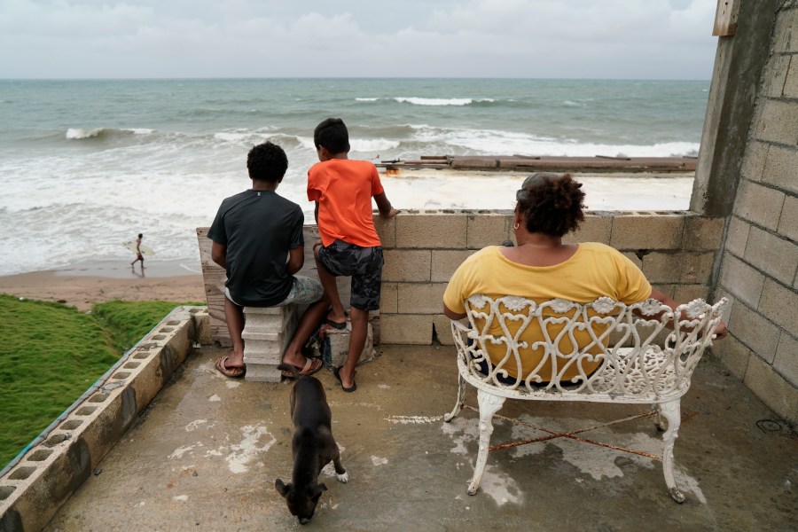 People look out to sea as Tropical Storm Karen approaches in Yabucoa, Puerto Rico, Sept. 24, 2019. (Credit: ERIC ROJAS/AFP/Getty Images)