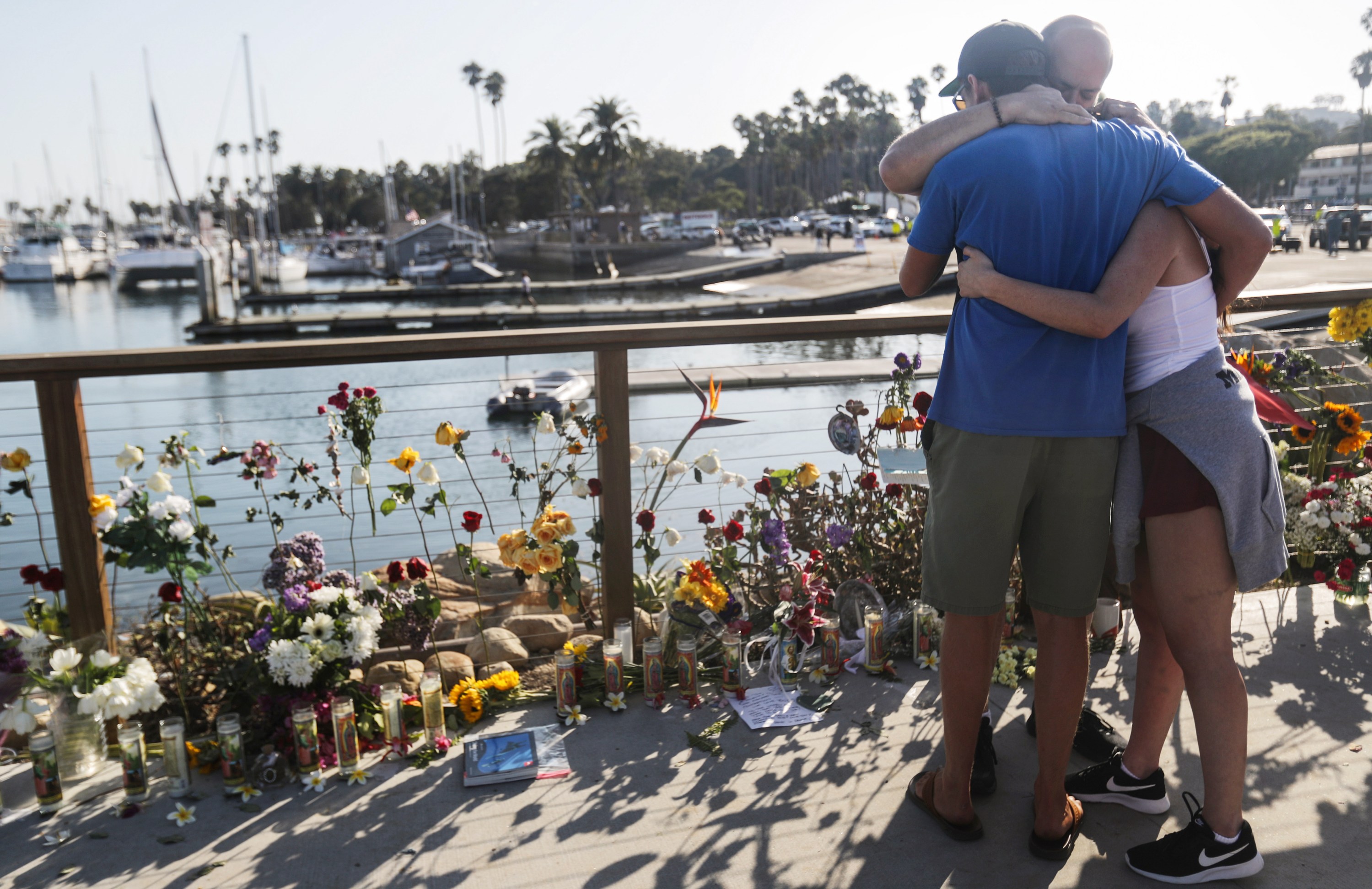 People embrace at Santa Barbara Harbor at a makeshift memorial for victims of the Conception boat fire on Sept. 3, 2019 in Santa Barbara. (Credit: Mario Tama/Getty Images)