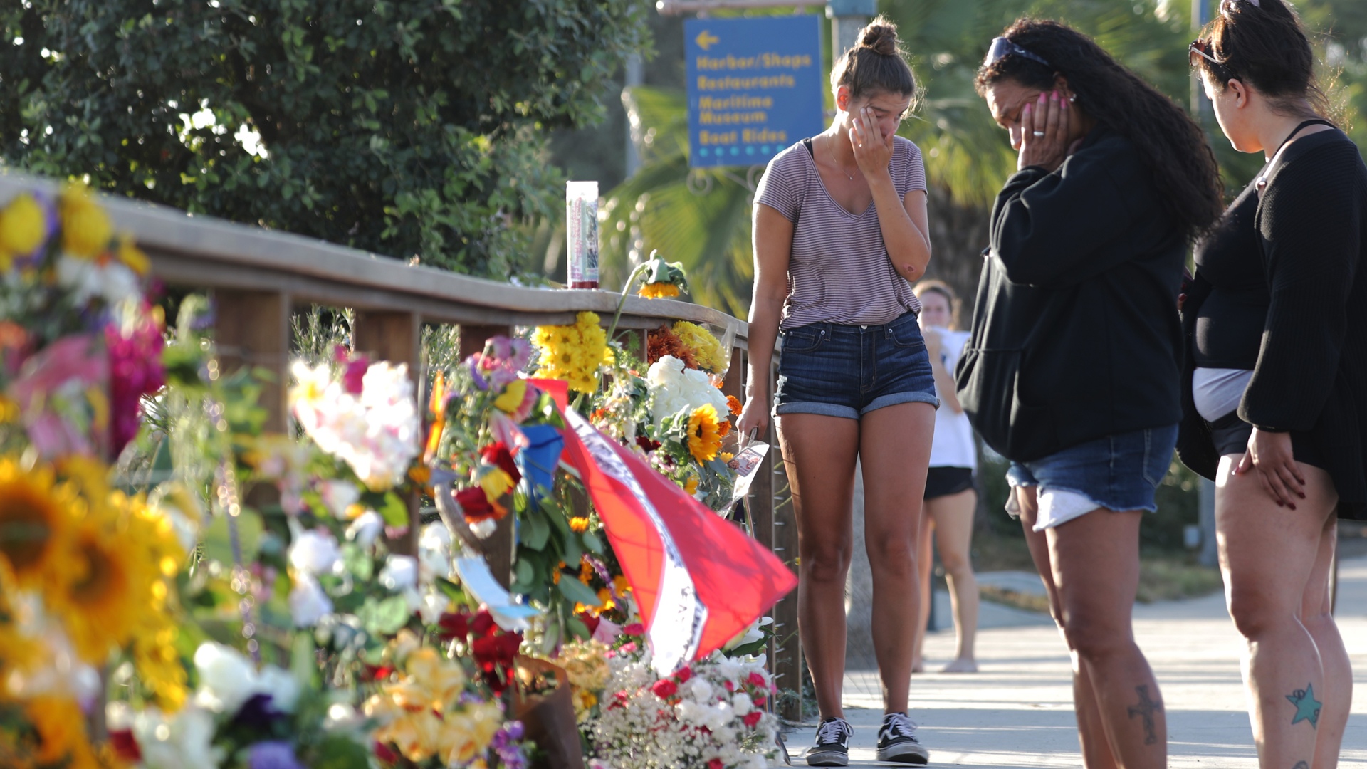 A woman cries as she stands in front of a makeshift memorial in Santa Barbara Harbor for victims of the Conception boat fire on Sept. 3, 2019. (Credit: Mario Tama/Getty Images)