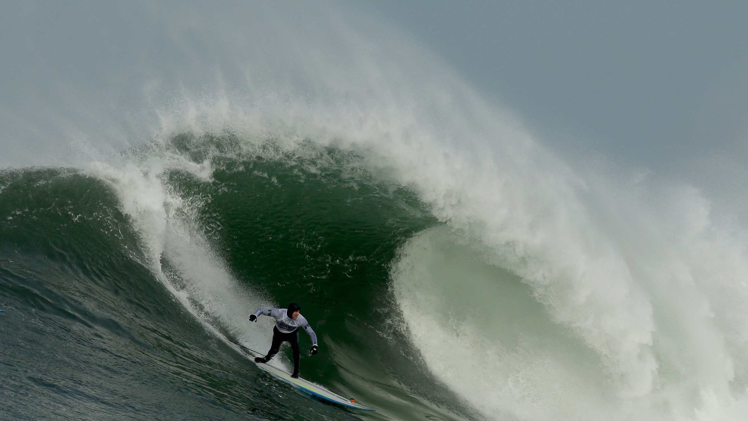 Grant Washburn rides a wave during the second heat of round one of Mavericks Invitational on January 24, 2014 in Half Moon Bay, California. (Credit: Ezra Shaw/Getty Images)