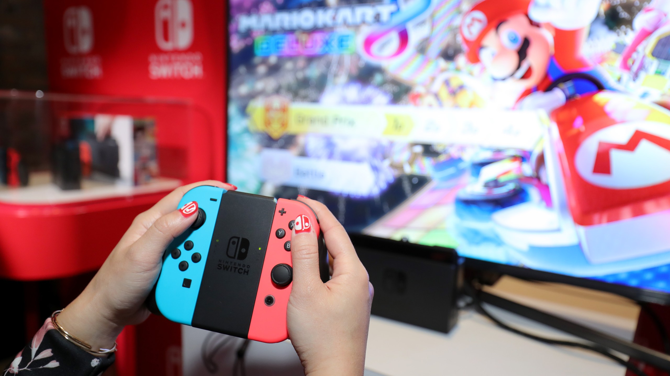 A guest enjoys playing Mario Kart 8 Deluxe on the new Nintendo Switch at a special preview event in New York on Jan. 13, 2017. Launching in March 3, 2017, Nintendo announced on Feb. 1, 2018, that Mario Kart will soon be available on mobile phones. (Credit: Neilson Barnard/Getty Images for Nintendo of America)