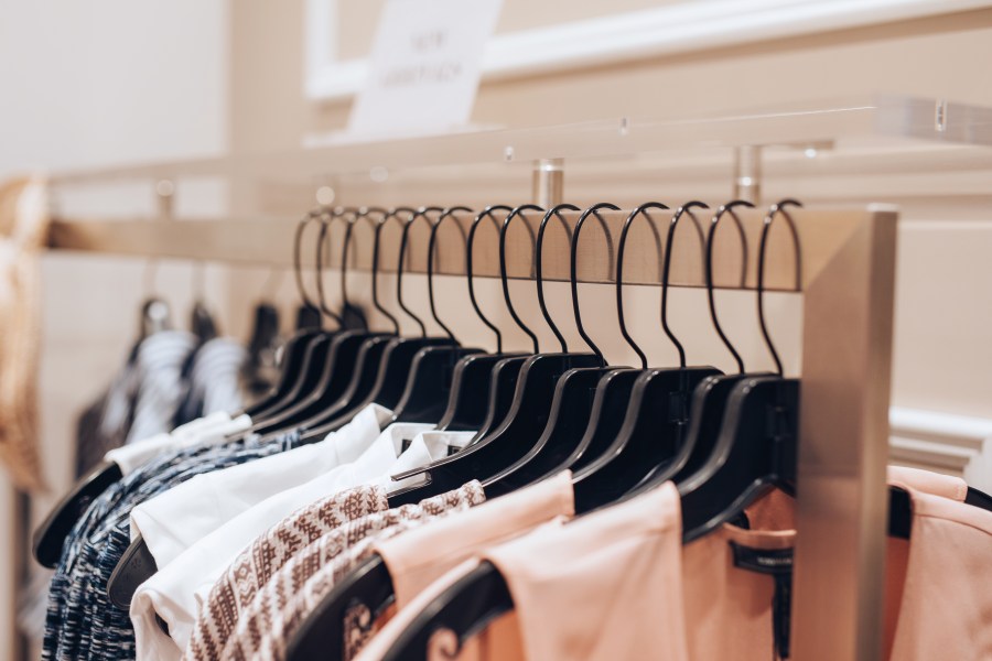 A file photo shows dresses on a rack in a clothing store. (Credit: Getty Images)