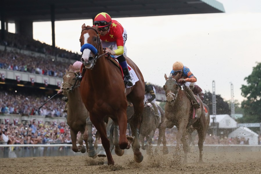 Justify #1, ridden by jockey Mike Smith crosses the finish line to win the 150th running of the Belmont Stakes at Belmont Park on June 9, 2018 in Elmont, New York. (Credit: Rob Carr/Getty Images)