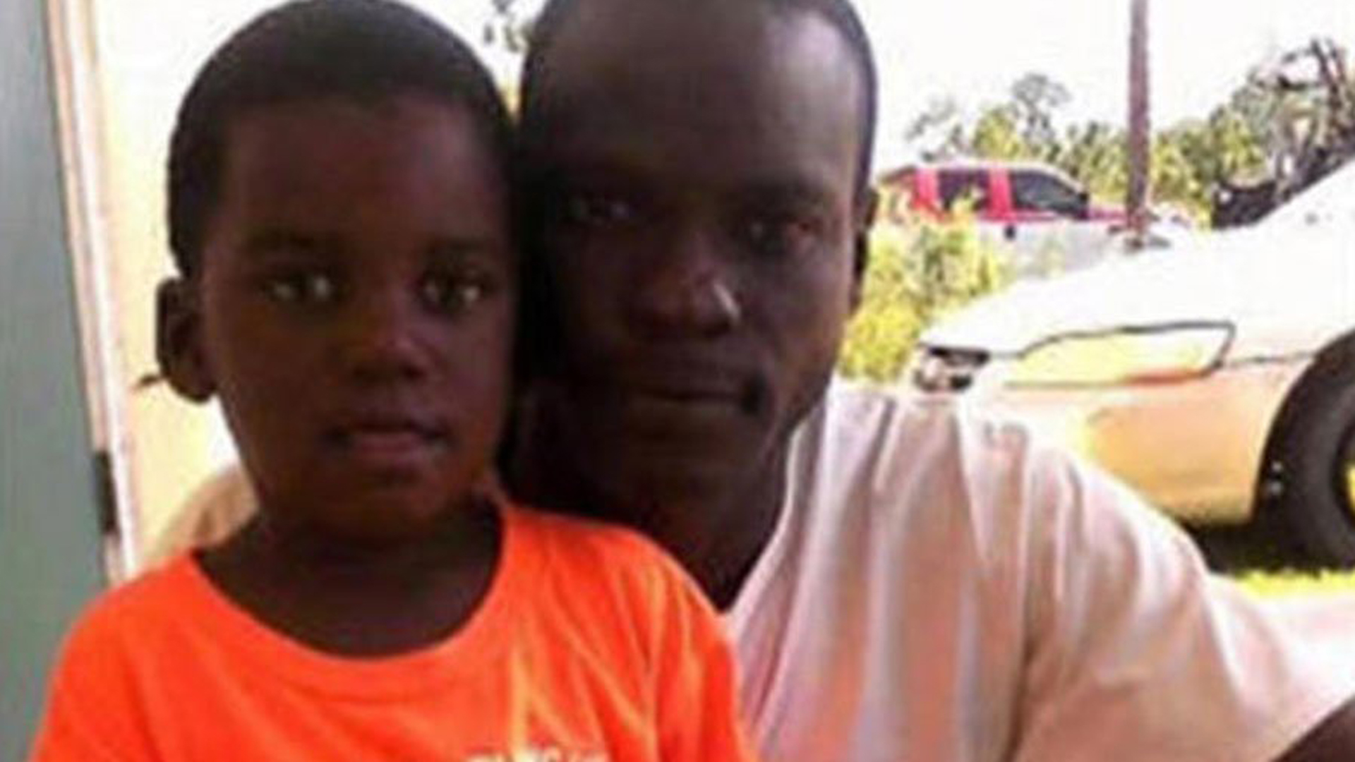 Adrian Farrington and his son, Adrian Jr. are seen in a family photo provided by CNN.