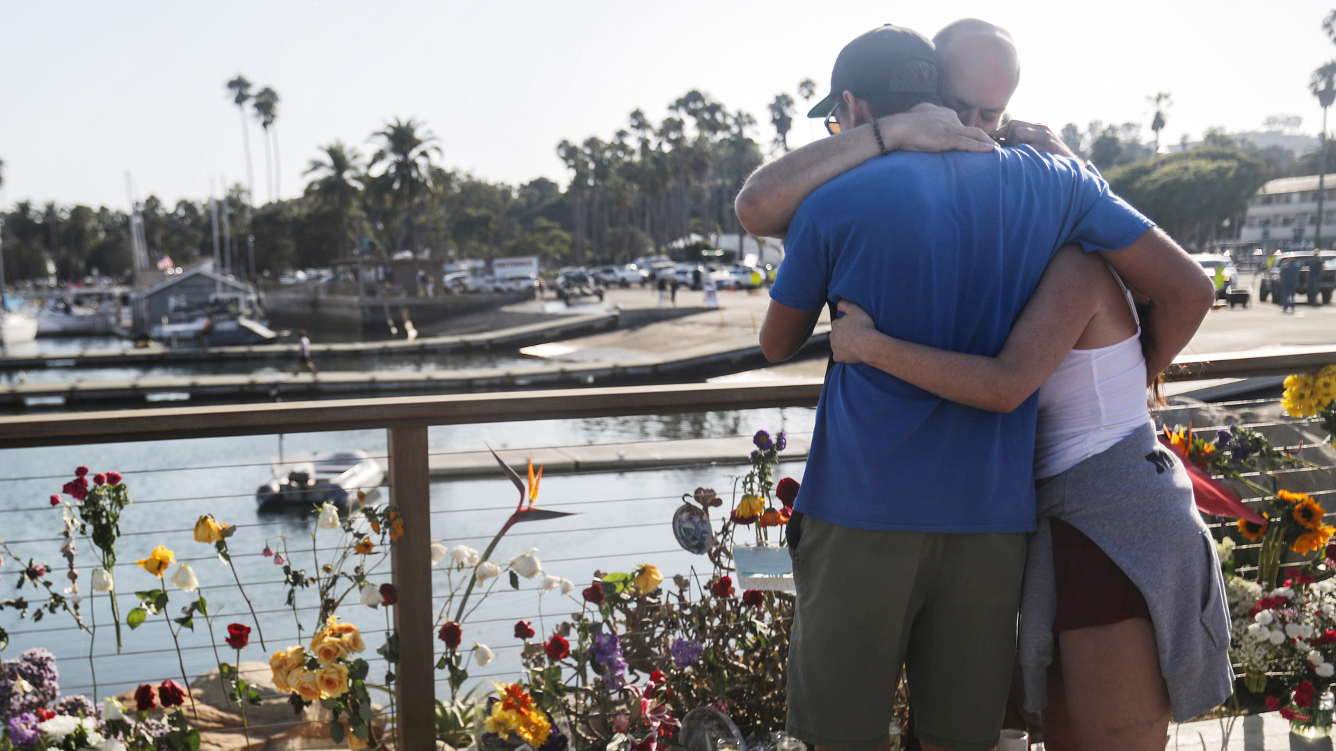 People embrace at Santa Barbara Harbor at a makeshift memorial for victims of the Conception boat fire on Sept. 3, 2019 in Santa Barbara. (Credit: Mario Tama/Getty Images)