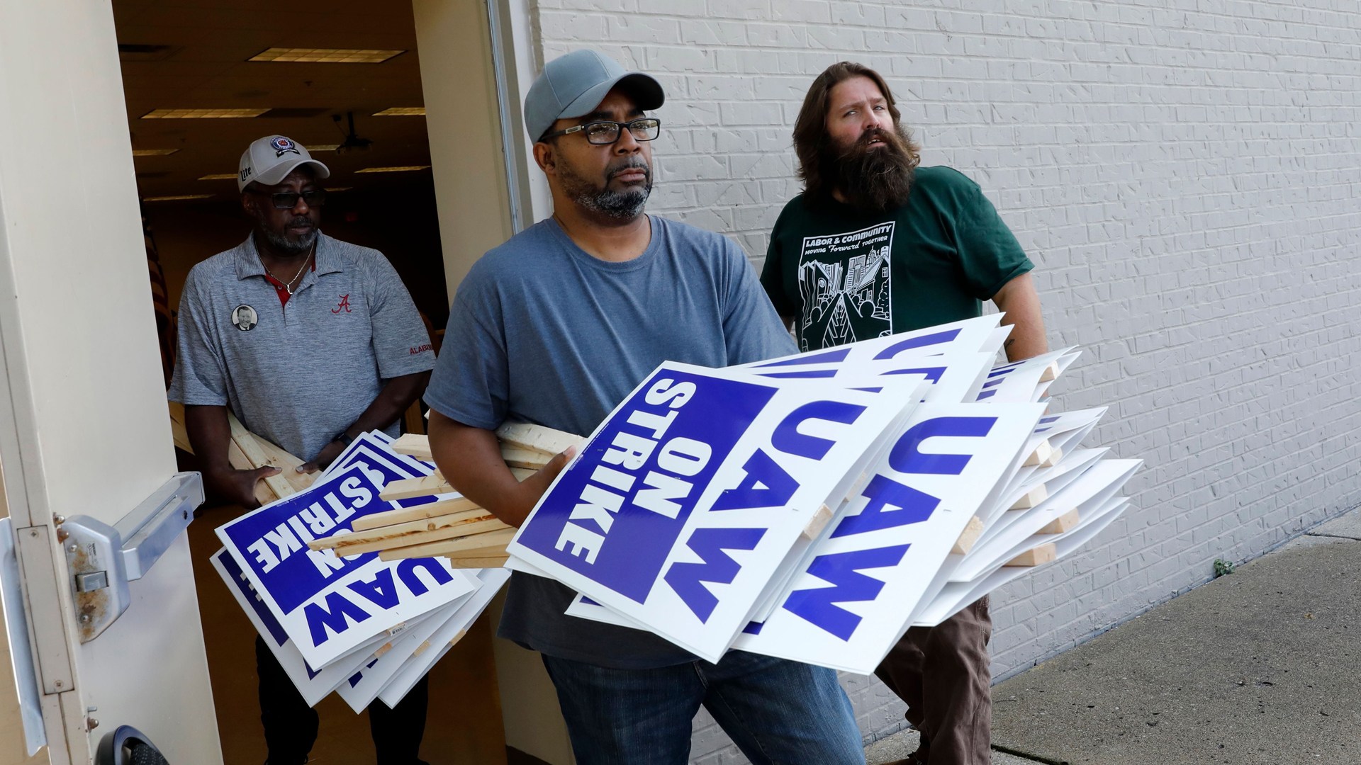 General Motors Co. employee Carl Ellison carries strike signs outside of the United Auto Workers (UAW) Local 163 which represents GMs Romulus Powertrain on September 15, 2019 in Westland, Michigan. (Credit: Jeff Kowalsky/AFP/Getty Images)