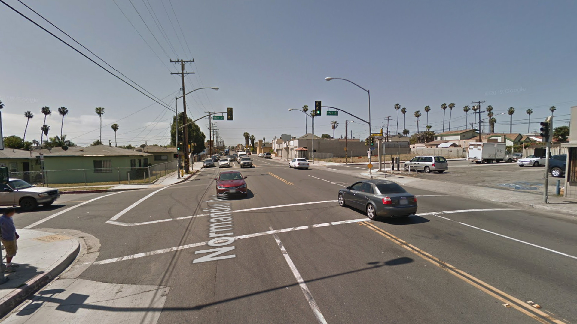 The intersection of Normandie Avenue and 95th Street in the Westmont neighborhood of South Los Angeles, as viewed in a Google Street View image.