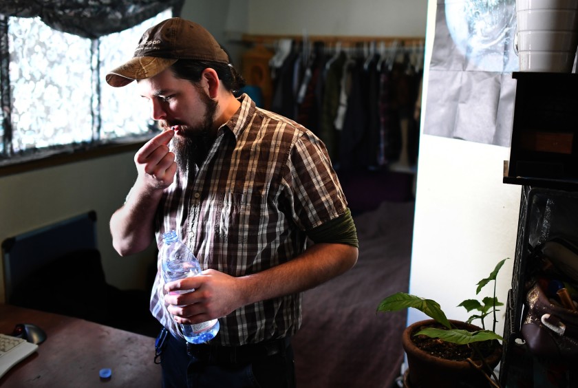 Rand Hunt, 34, takes PrEP in his bedroom in Oakland sometime in the fall of 2019. He was born the year HIV was identified and has lived his entire life in the shadow of the AIDS epidemic. (Credit: Wally Skalij / Los Angeles Times)