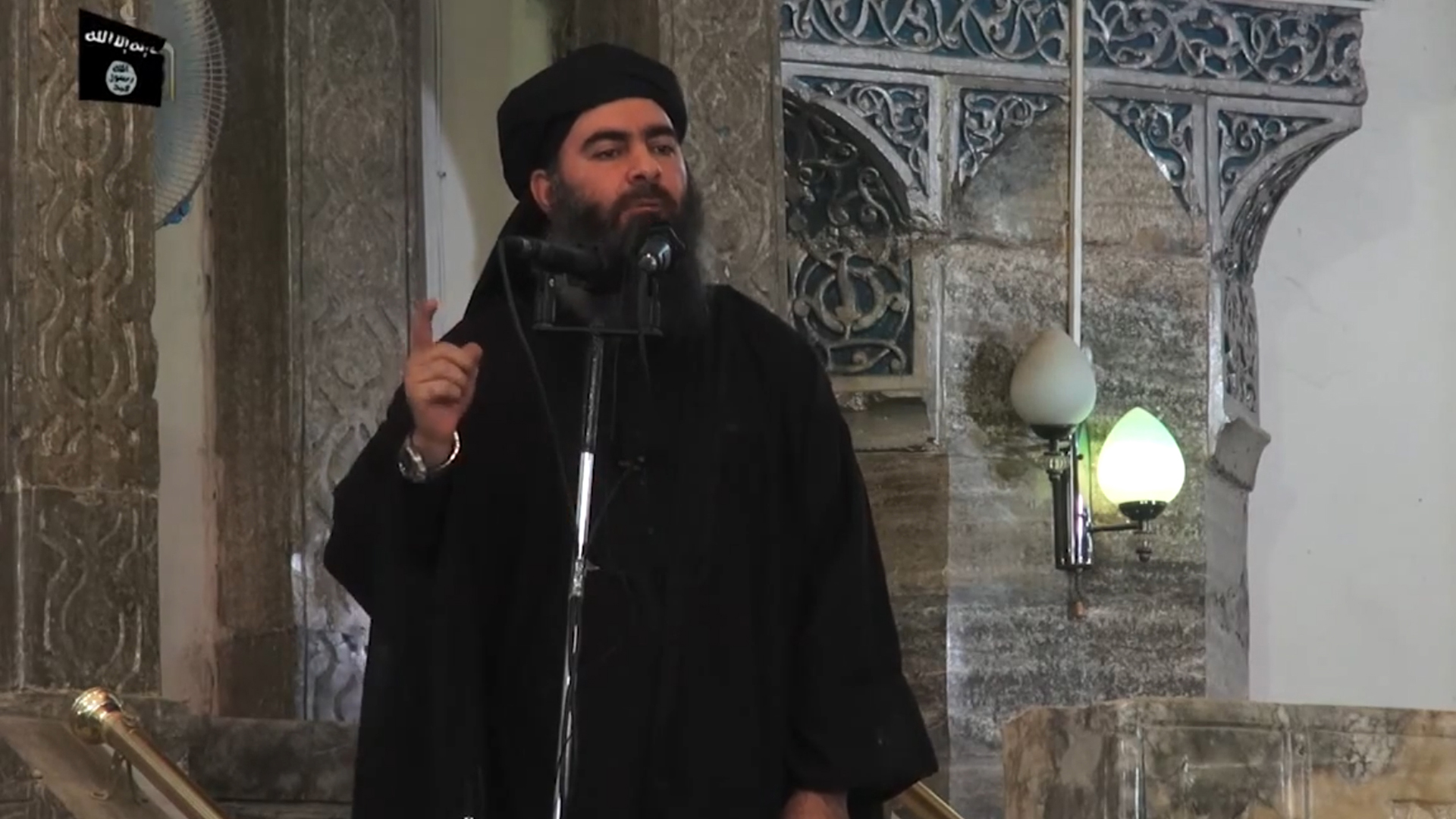 In this file picture taken on July 5, 2014, an image grab taken from a propaganda video released by al-Furqan Media allegedly shows the leader of the Islamic State (IS) jihadist group, Abu Bakr al-Baghdadi, aka Caliph Ibrahim, addressing Muslim worshippers at a mosque in the militant-held northern Iraqi city of Mosul. (Credit: AFP/Getty Images)