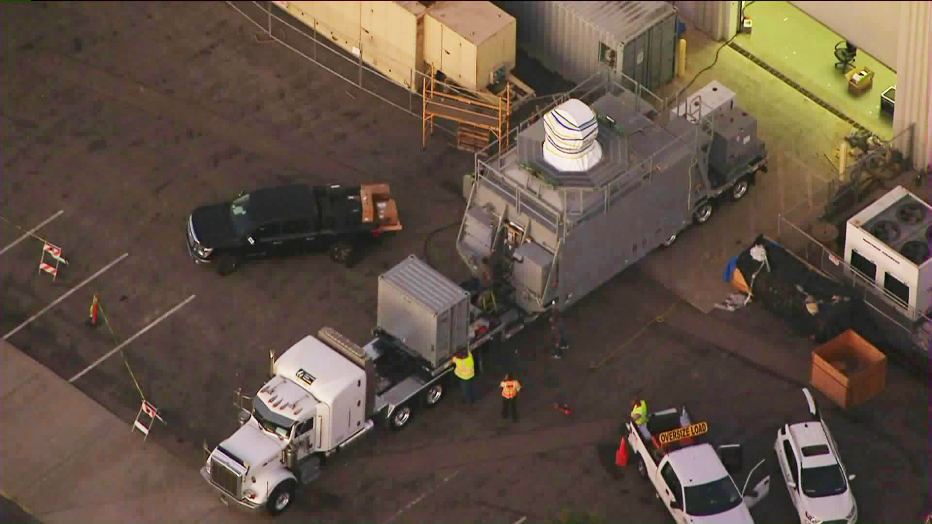 Officials move an undisclosed cargo from a Northrop Grumman Facility in Redondo Beach en route to a barge to be transported to San Diego as part of a U.S. Navy project on Oct. 18, 2019. (Credit: KTLA)