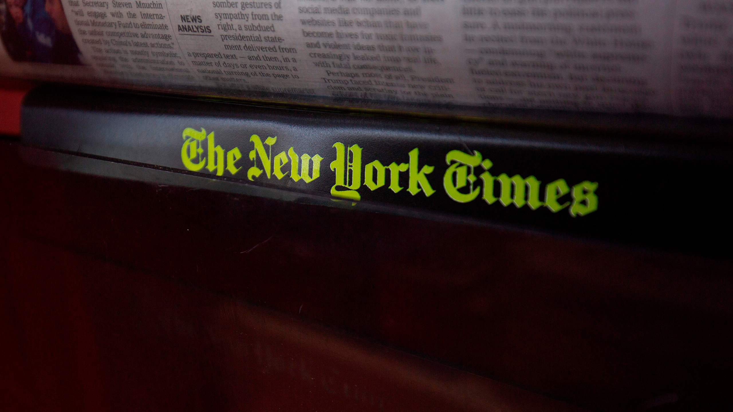 The New York Times logo is seen on a newspaper rack at a convenience store in Washington, D.C., on Aug. 6, 2019. (Credit: ALASTAIR PIKE/AFP/Getty Images)