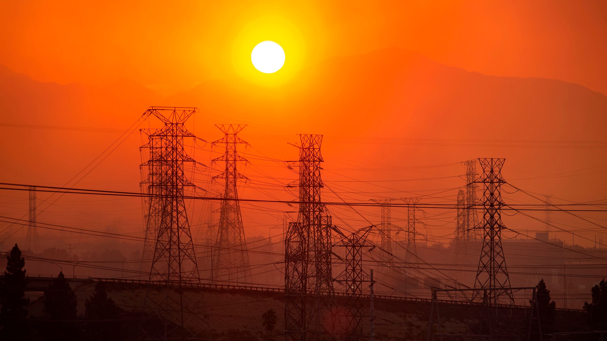 The sun rises over power lines along a smokey horizon during the Saddleridge Fire in Newhall on Oct. 11, 2019. (Credit: Josh Edelson/AFP via Getty Images)