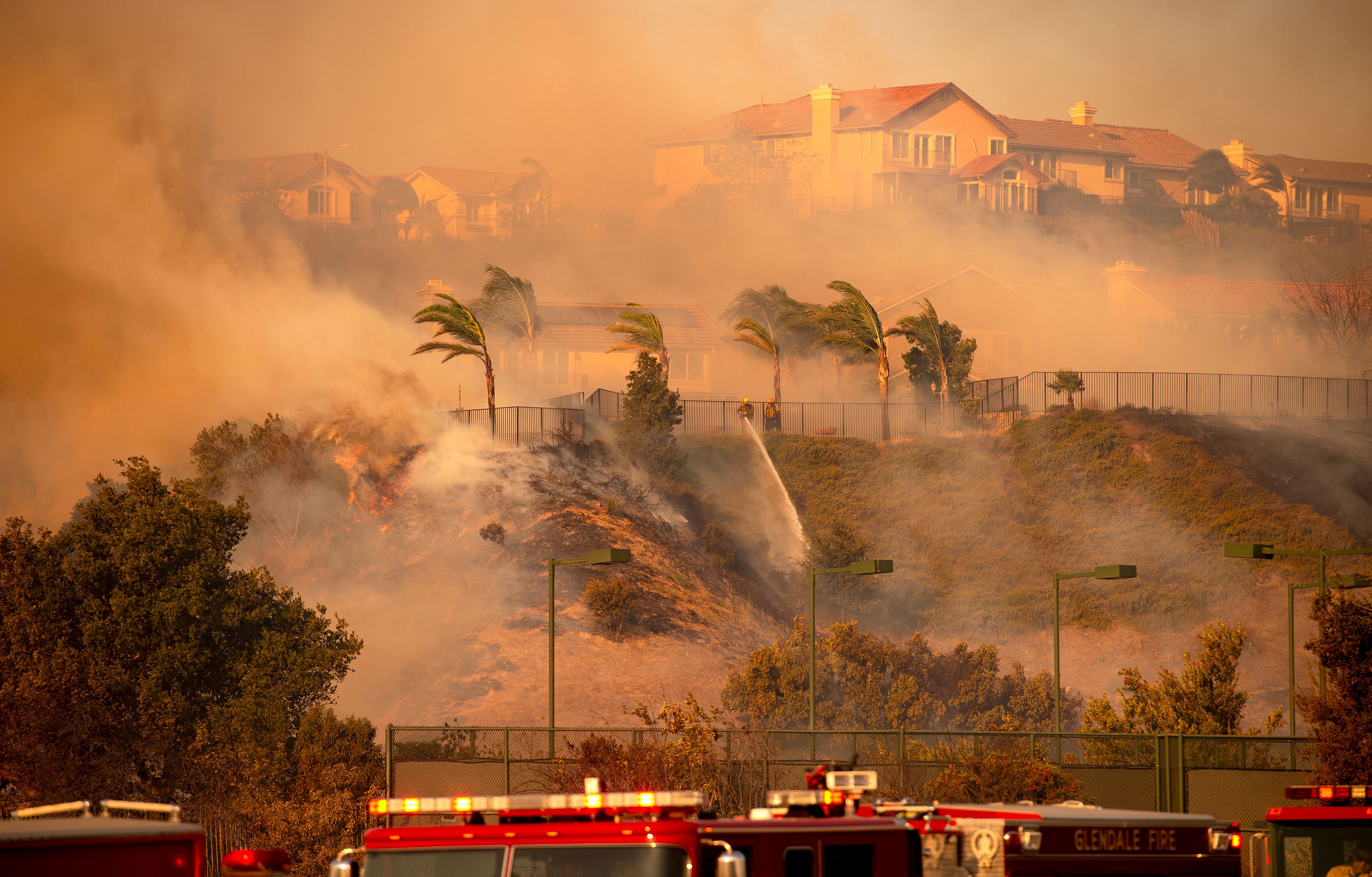 Wind whips through the area as firefighters fight impending flames during the Saddleridge Fire in the Porter Ranch section of Los Angeles on Oct. 11, 2019. (JOSH EDELSON/AFP via Getty Images)