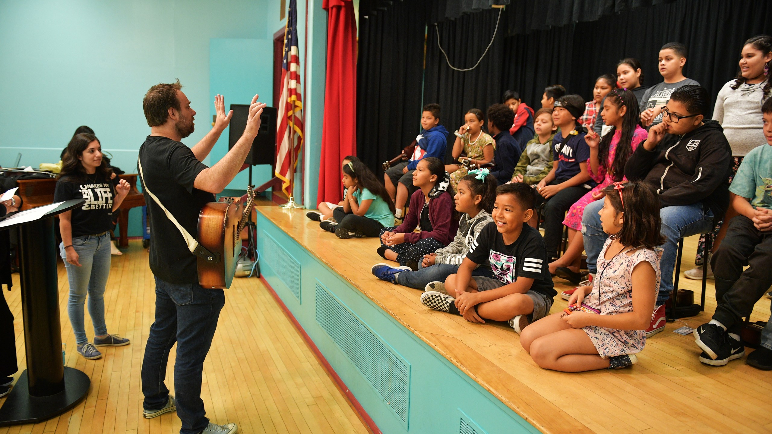 Phil Barton and fifth graders practice onstage during the Country Music Hall of Fame and Museum Brings Words and Music Program at Elysian Heights Elementary School on Sept. 16, 2019, in Los Angeles. (Credit: Matt Winkelmeyer/Getty Images for Country Music Hall of Fame and Museum)