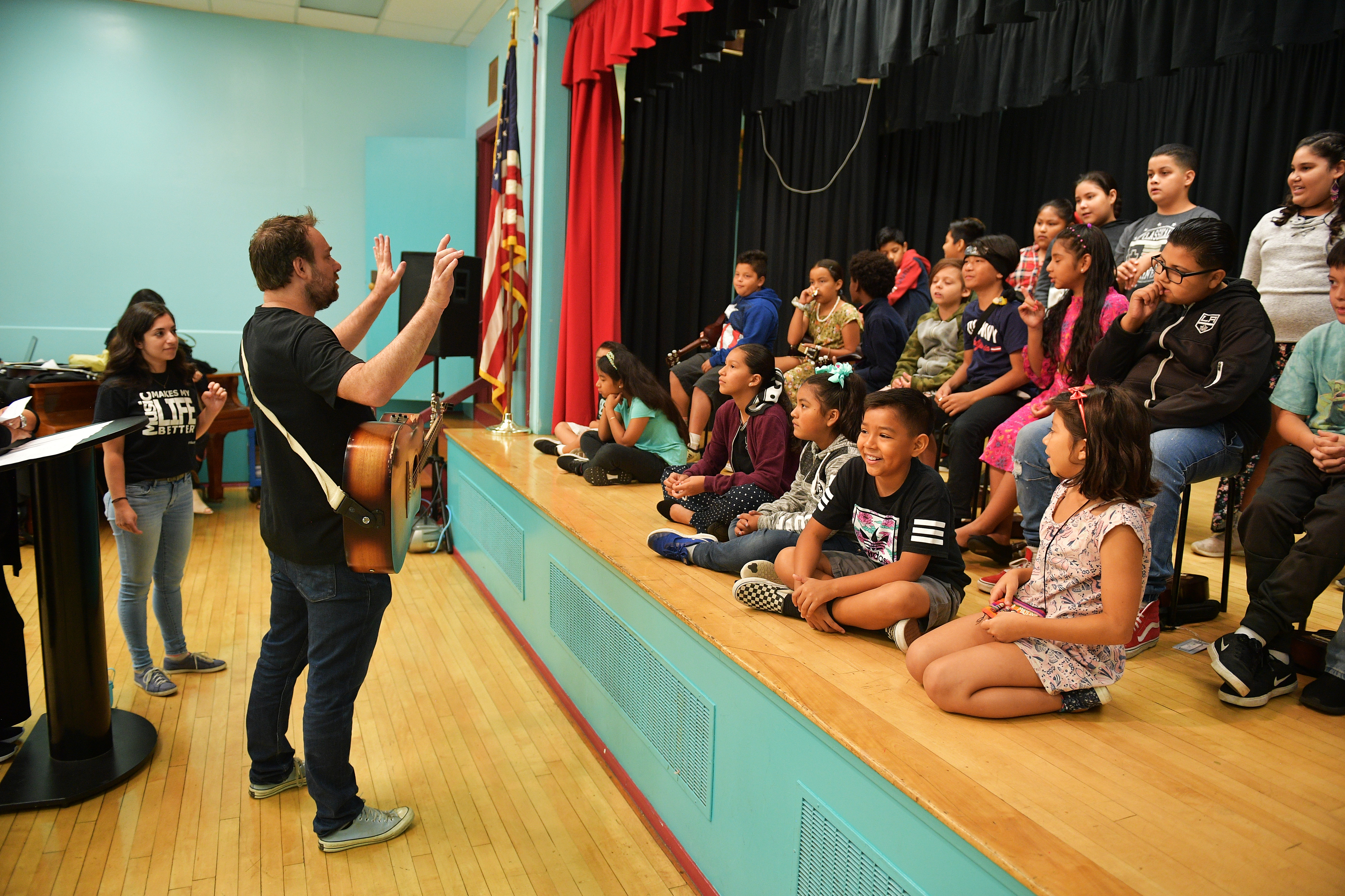 Phil Barton and fifth graders practice onstage during the Country Music Hall of Fame and Museum Brings Words and Music Program at Elysian Heights Elementary School on Sept. 16, 2019, in Los Angeles. (Credit: Matt Winkelmeyer/Getty Images for Country Music Hall of Fame and Museum)