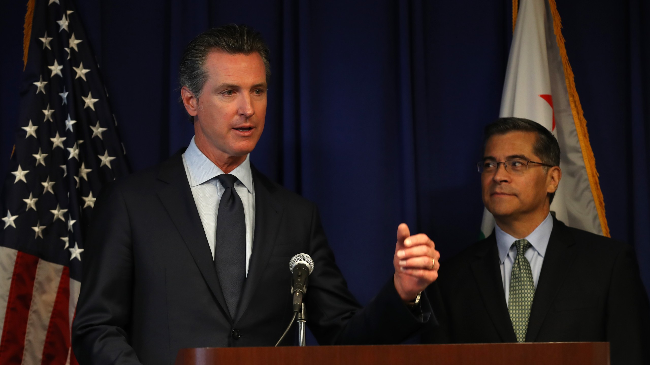 California attorney general Xavier Becerra looks on as California Gov. Gavin Newson speaks during a news conference at the California justice department on Sept. 18, 2019, in Sacramento. (Credit: Justin Sullivan/Getty Images)