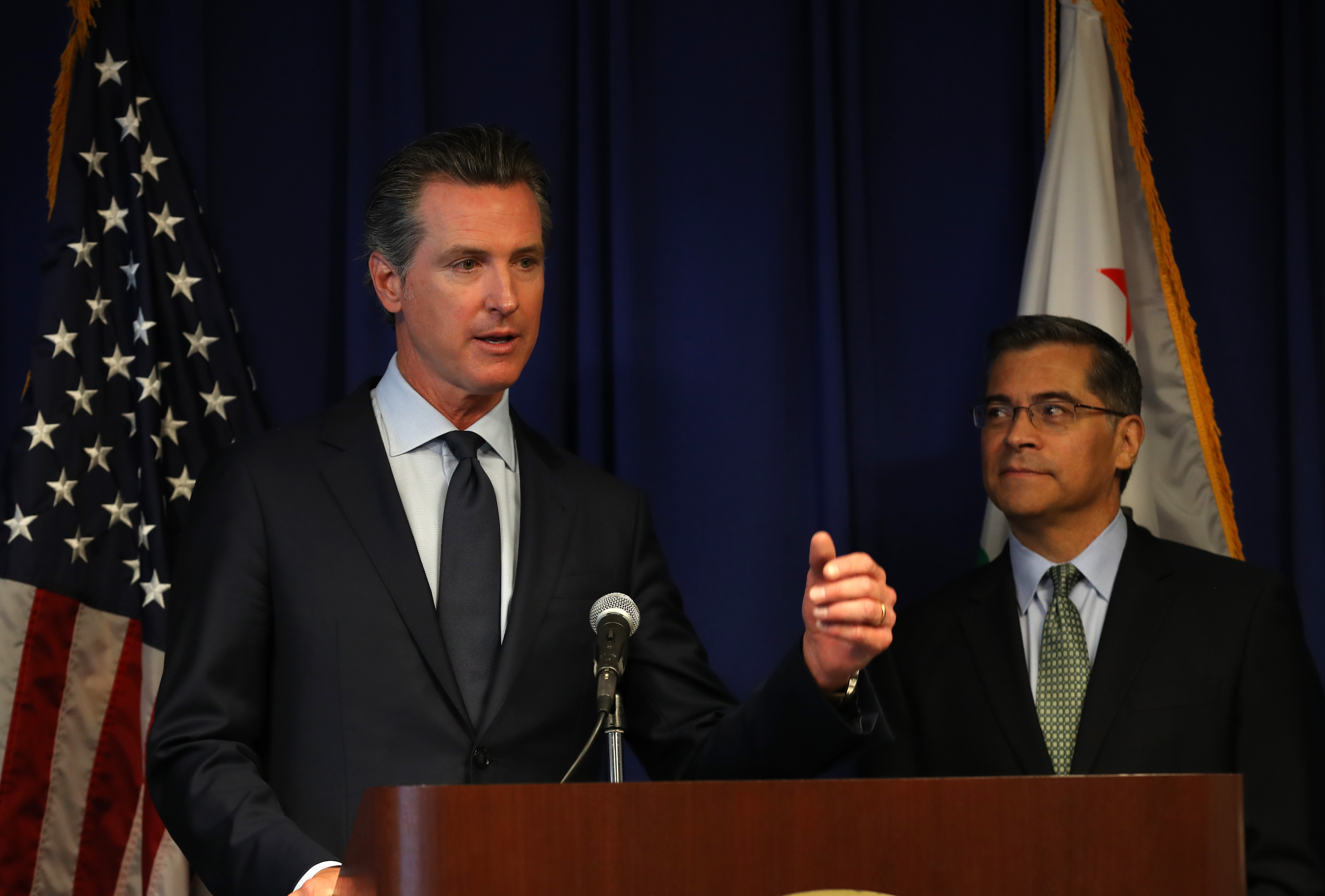 California attorney general Xavier Becerra looks on as California Gov. Gavin Newson speaks during a news conference at the California justice department on Sept. 18, 2019, in Sacramento. (Credit: Justin Sullivan/Getty Images)