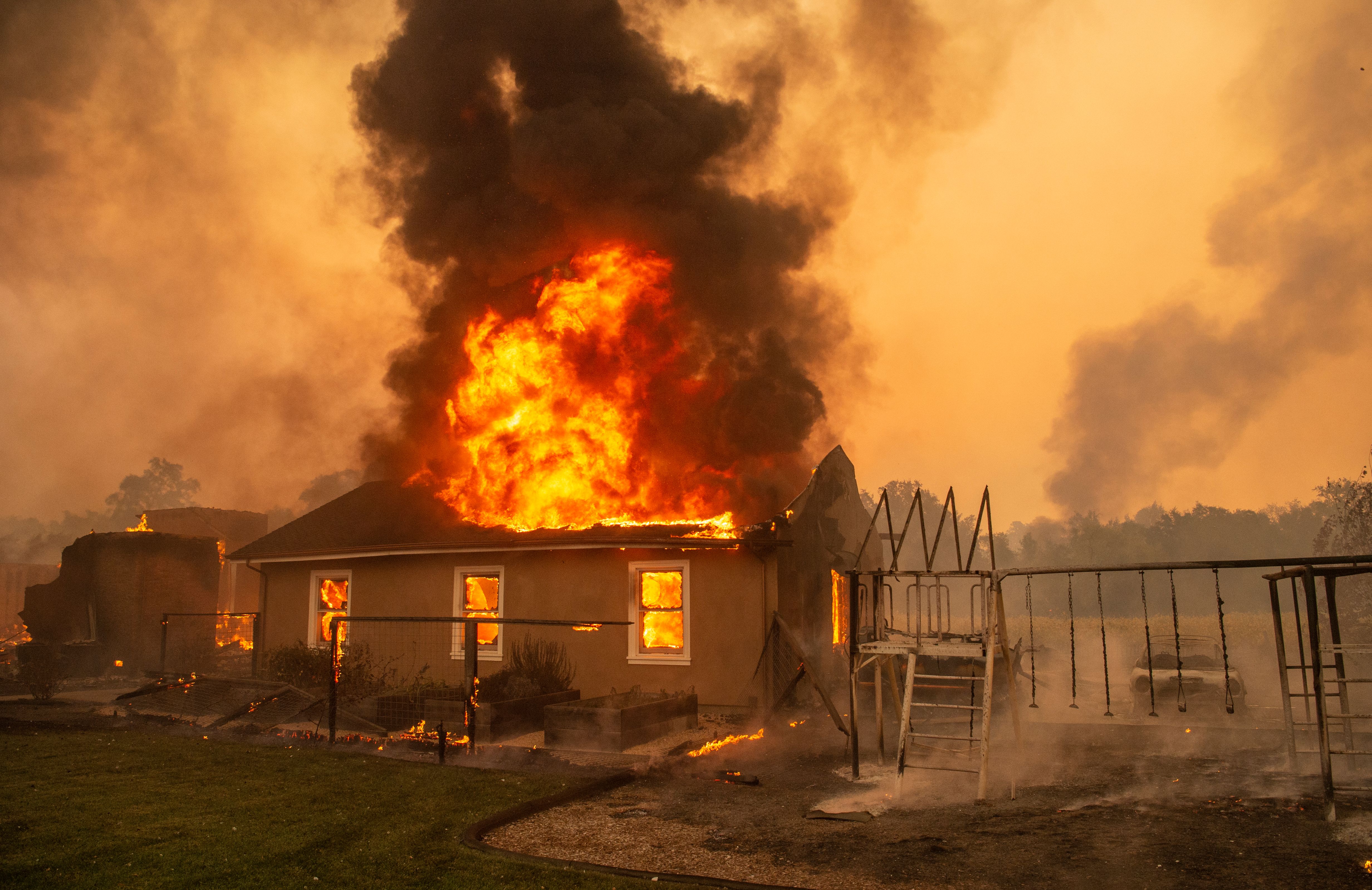 A home burns at a vineyard during the Kincade fire near Geyserville, California on Oct. 24, 2019. (Credit: Josh Edelson/AFP via Getty Images)