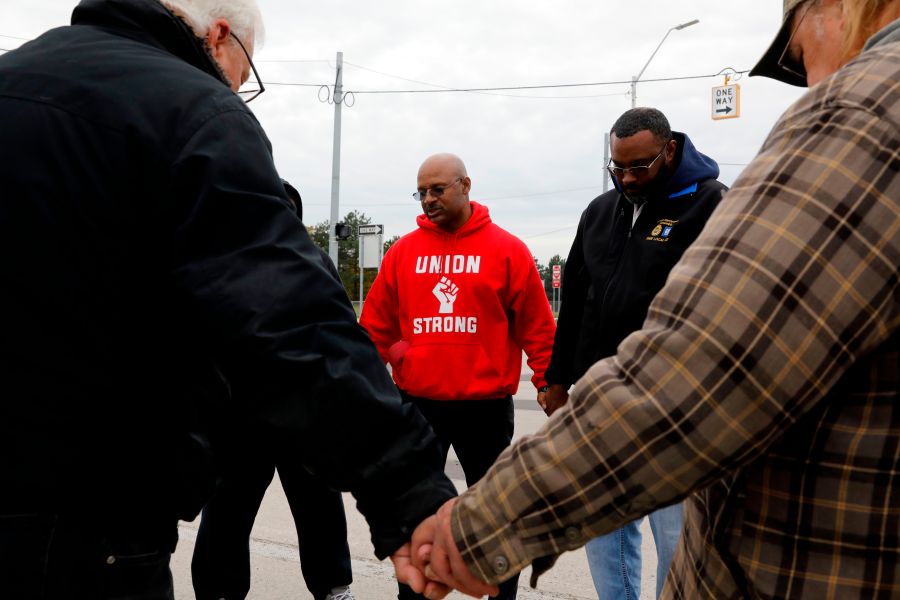 United Auto Workers member Joe Ryan, center, leads a prayer circle to recite a strike closing prayer outside of the General Motors Detroit-Hamtramck Assembly plant in Detroit, Michigan, on Oct. 25, 2019. (Credit: Jeff Kowalsky / AFP / Getty Images)