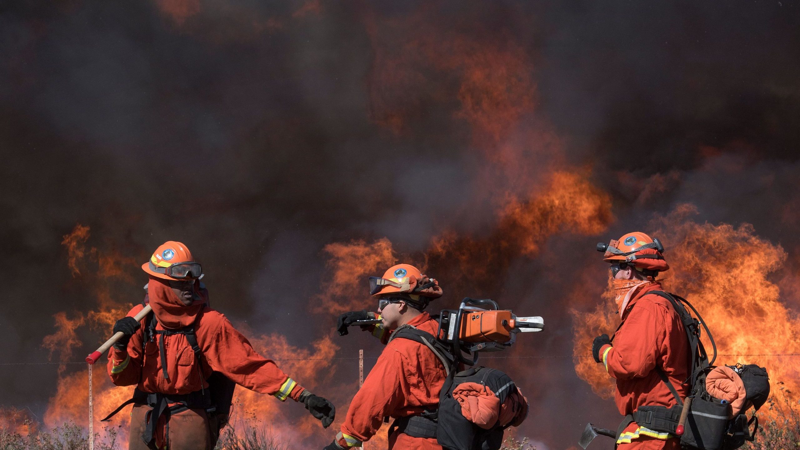 Inmate firefighters prepare to put out flames on the road leading to the Reagan Library during the Easy Fire in Simi Valley, California on October 30, 2019. (Credit: Mark Ralston/AFP via Getty Images)