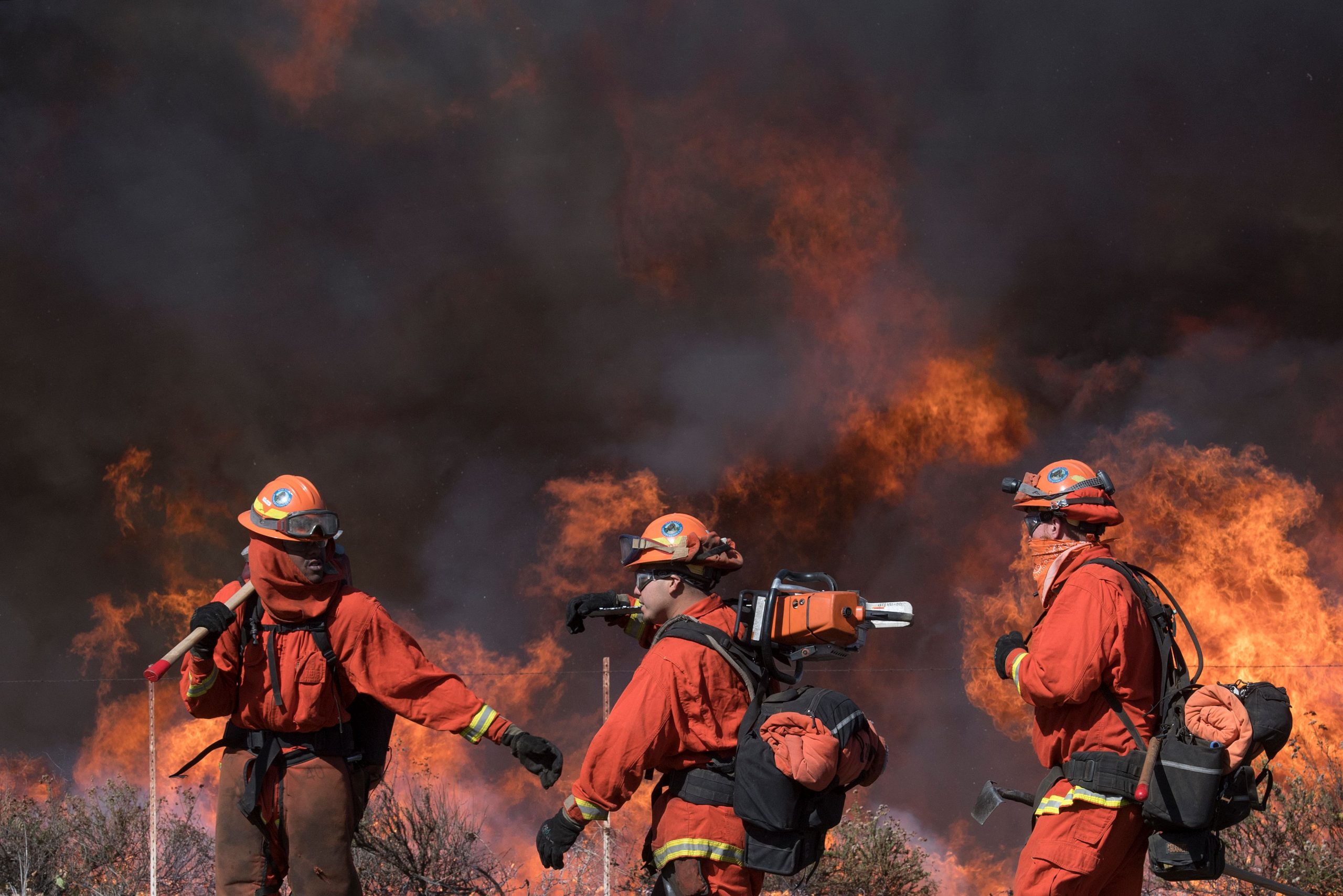 Inmate firefighters prepare to put out flames on the road leading to the Reagan Library during the Easy Fire in Simi Valley, California on October 30, 2019. (Credit: Mark Ralston/AFP via Getty Images)