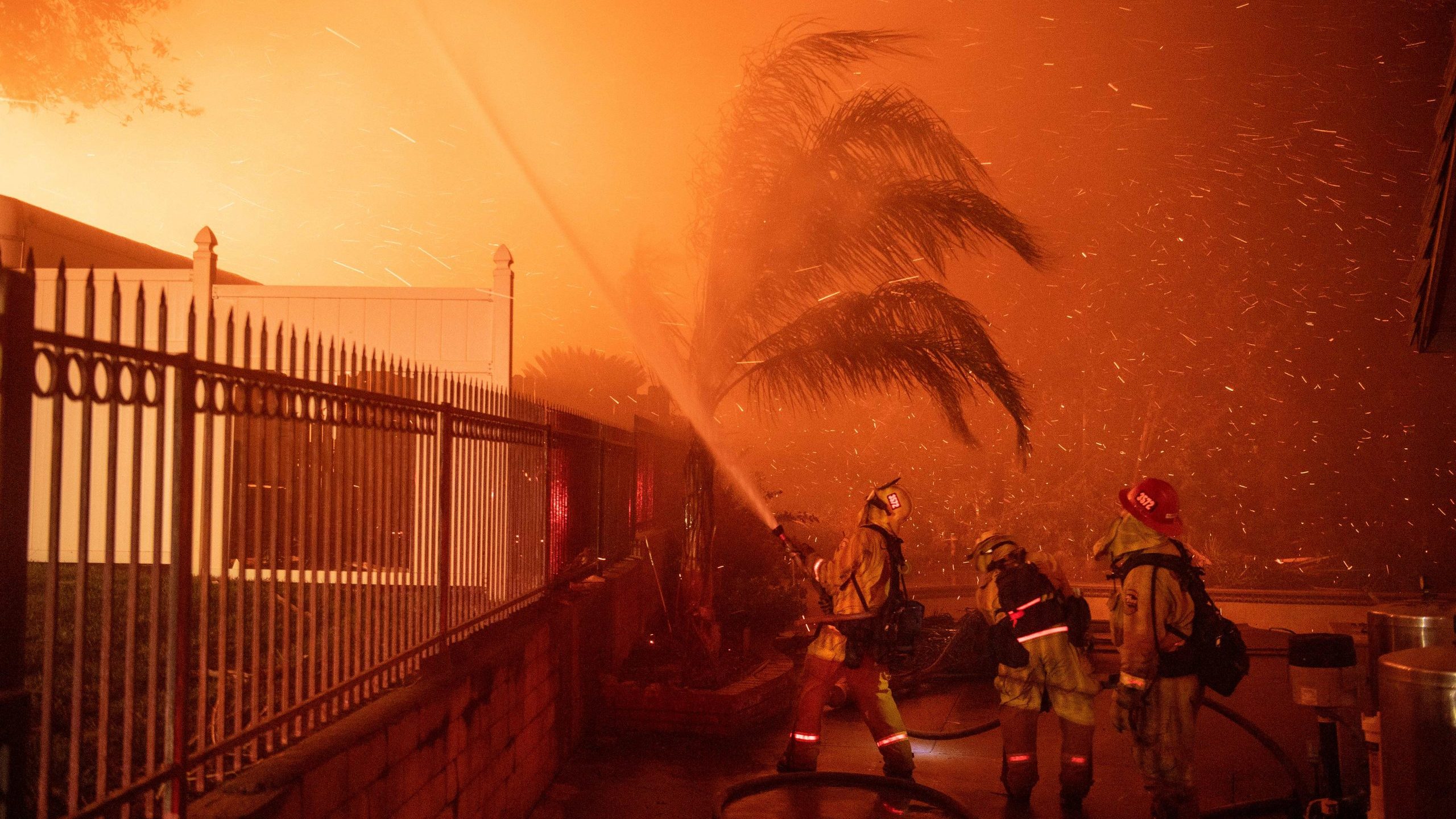 Firefighters battle wind-whipped flames engulfing multiple homes during the Hillside Fire in the North Park neighborhood of San Bernardino on Oct. 31, 2019. (Credit: Josh Edelson / AFP / Getty Images)