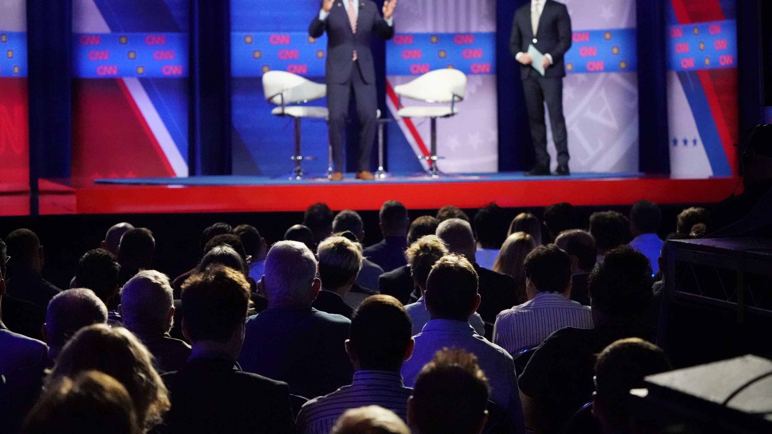 Audience members watch as Democratic presidential candidate and former Vice President Joe Biden speaks, as CNN moderator Anderson Cooper looks on, at the Human Rights Campaign Foundation and CNN’s presidential town hall focused on LGBTQ issues in Los Angeles on Oct. 10, 2019. (Credit: Mario Tama / Getty Images)