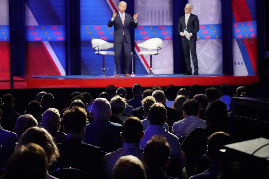 Audience members watch as Democratic presidential candidate and former Vice President Joe Biden speaks, as CNN moderator Anderson Cooper looks on, at the Human Rights Campaign Foundation and CNN’s presidential town hall focused on LGBTQ issues in Los Angeles on Oct. 10, 2019. (Credit: Mario Tama / Getty Images)