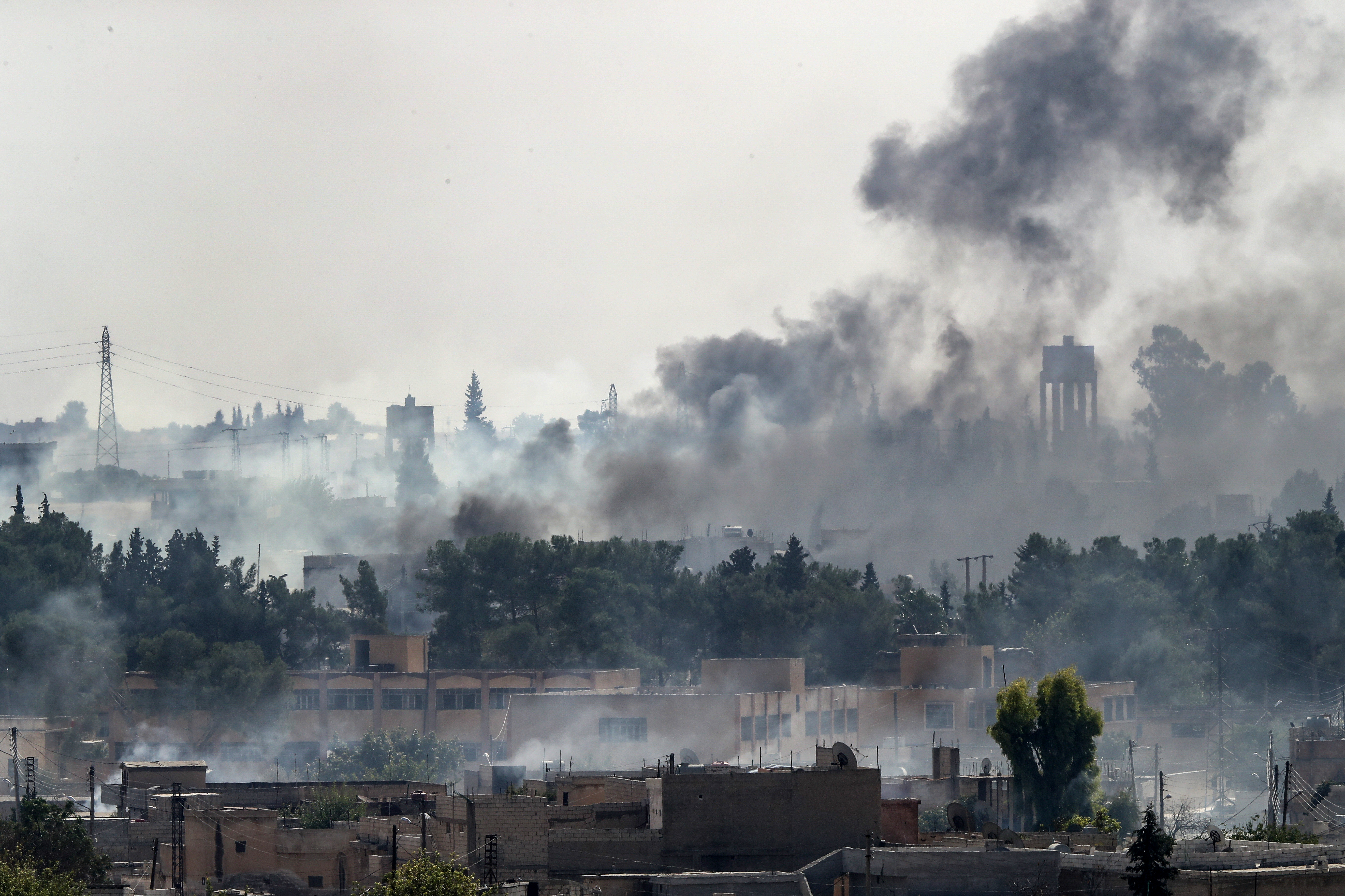 Smoke rises over the Syrian town of Tal Abyad, as seen from the Turkish border town of Akcakale on Oct. 13, 2019. (Credit: Burak Kara/Getty Images)