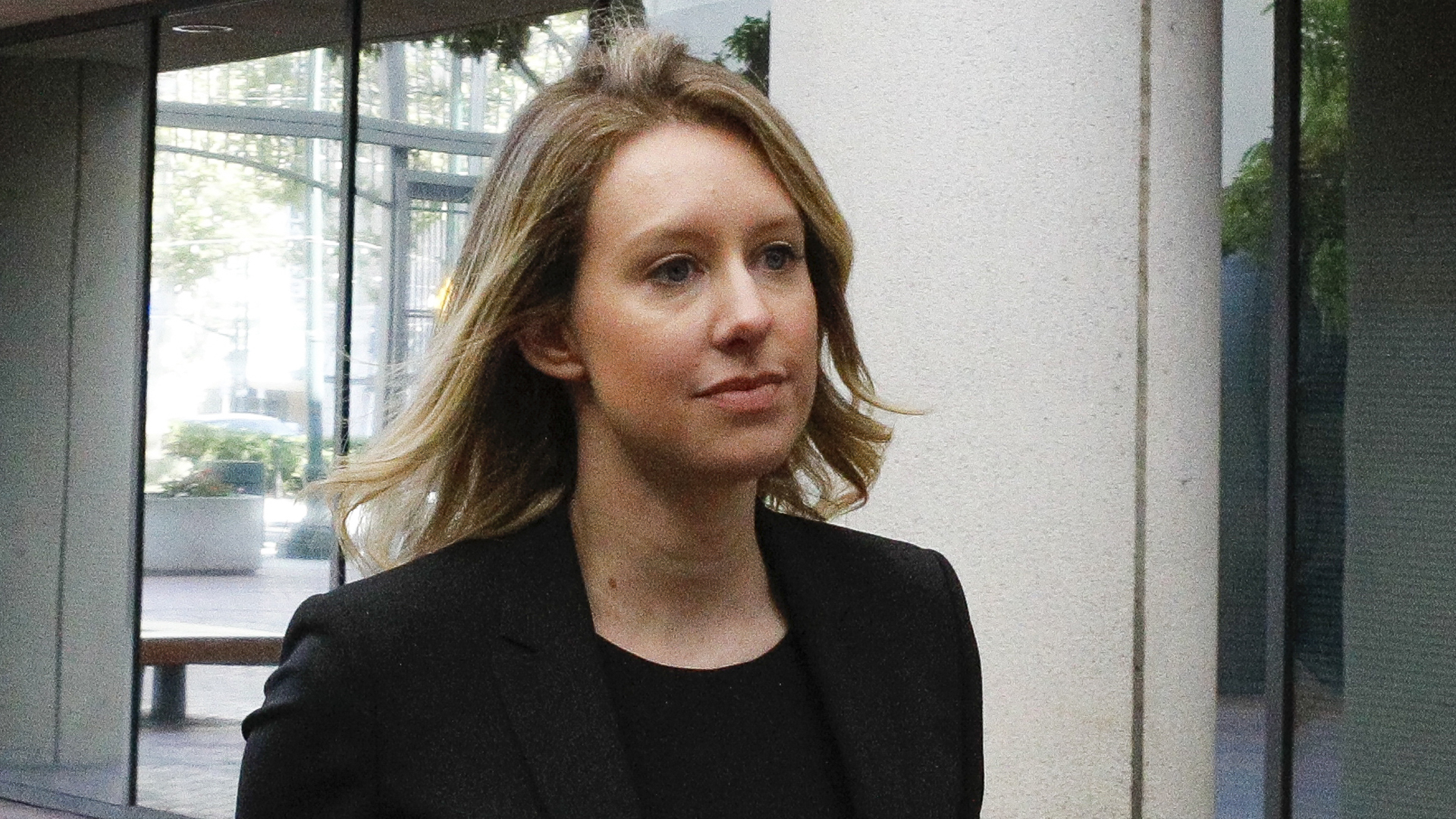 Former Theranos CEO Elizabeth Holmes walks to federal court for a status hearing on July 17, 2019, in San Jose, Calif. Holmes is facing charges of conspiracy and wire fraud for allegedly engaging in a multimillion-dollar scheme to defraud investors with the Theranos blood testing lab services. (Credit: Kimberly White/Getty Images)