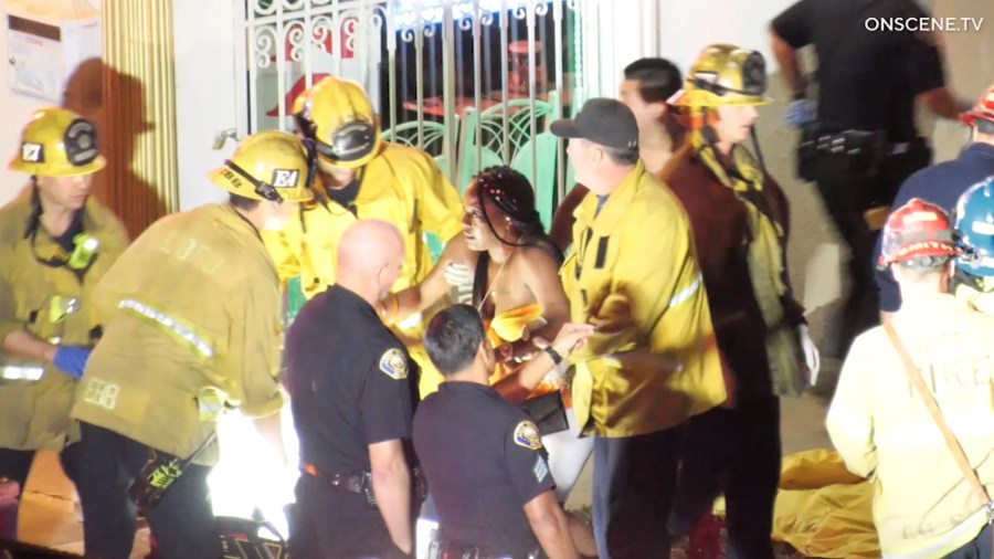 First responders assist a woman injured during a shooting at a house party in Long Beach on Oct. 29, 2019. (Credit: OnScene.TV)